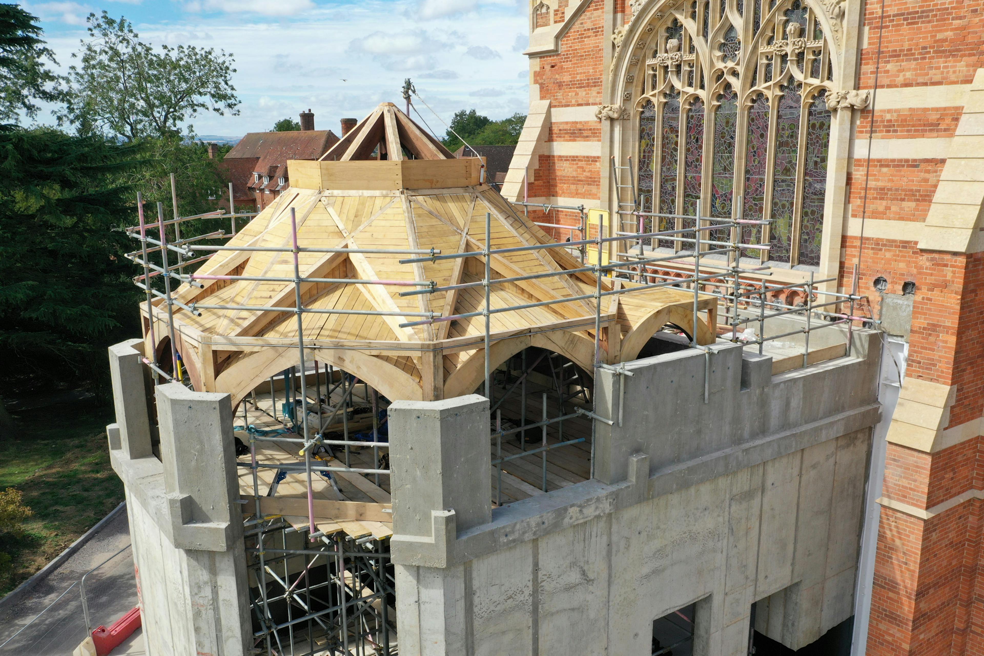 An extension to a 19th century chapel with an octagonal oak framed roof structure during construction 