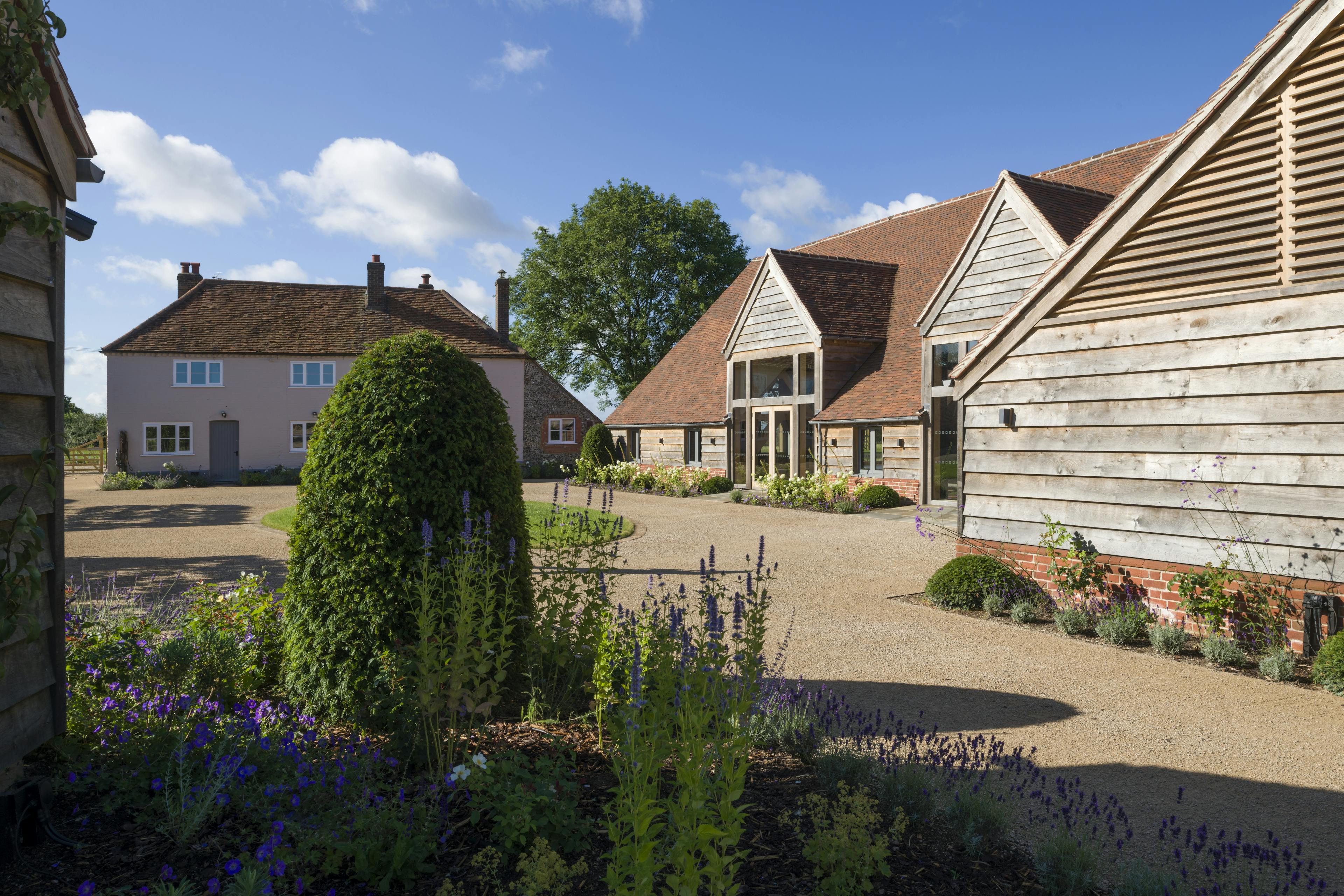 A red tiled oak framed wedding venue with landscaped gardens