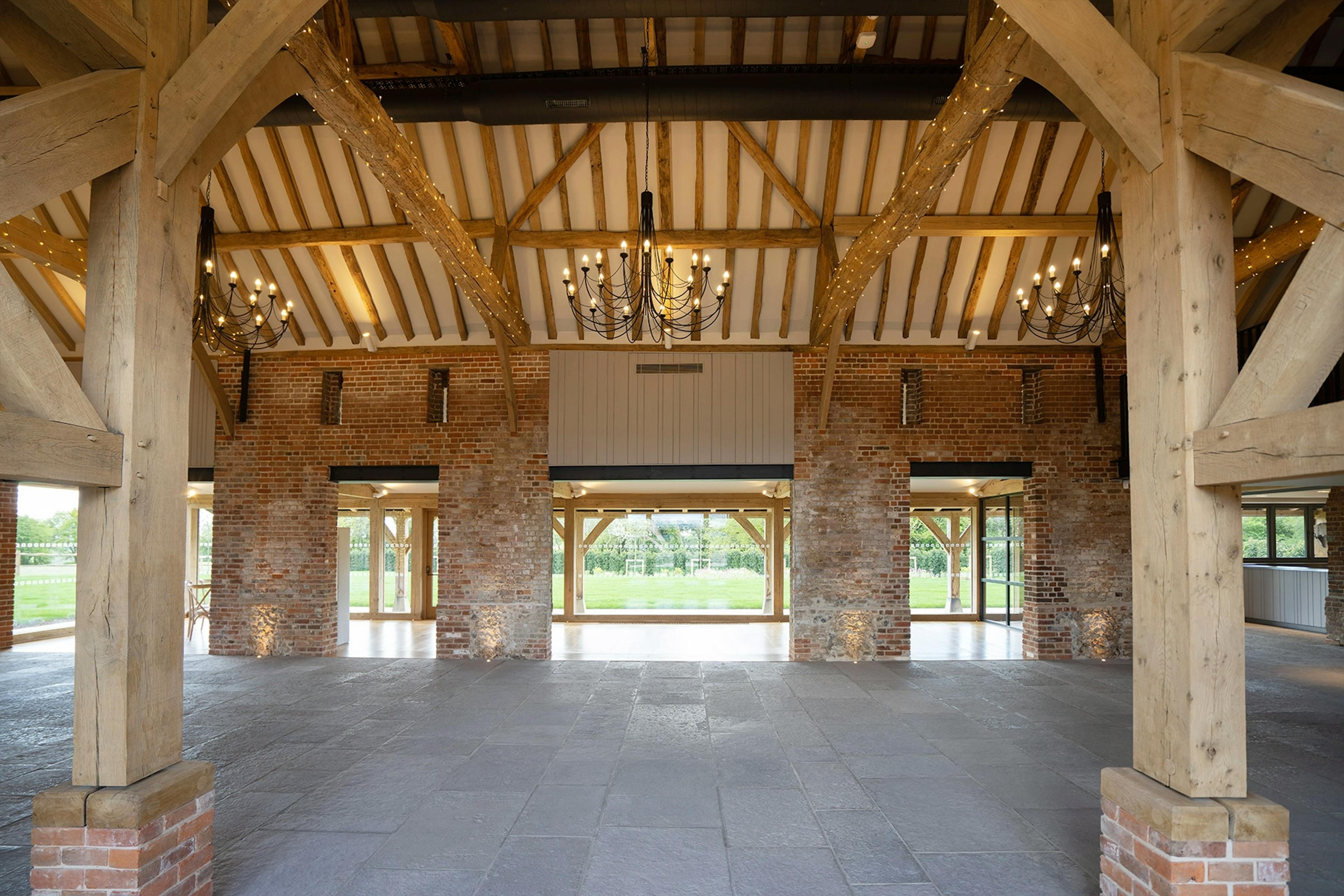 An oak framed wedding barn hall with oak posts on red brick post feet