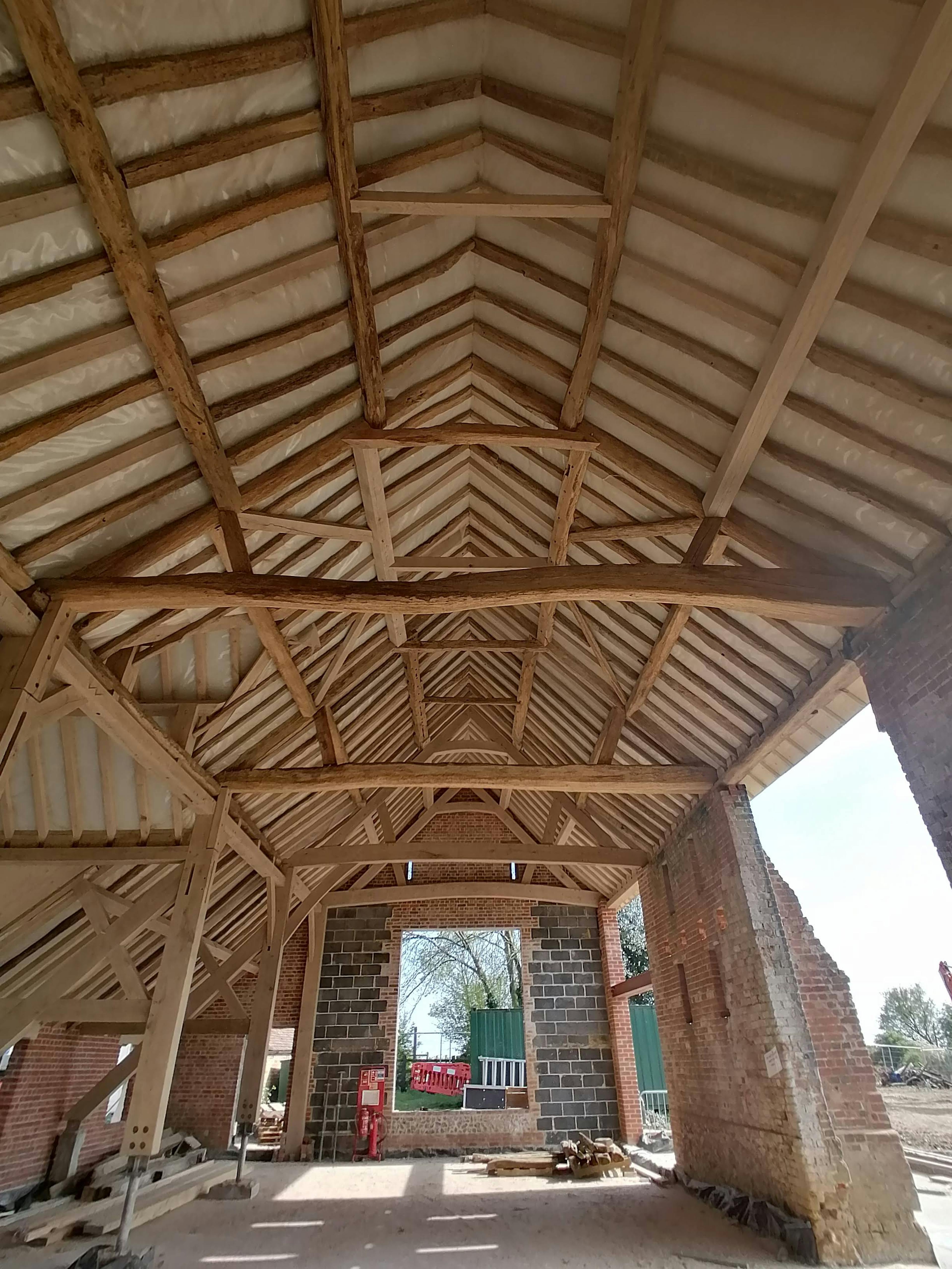 An oak framed wedding barn during restoration and installation 