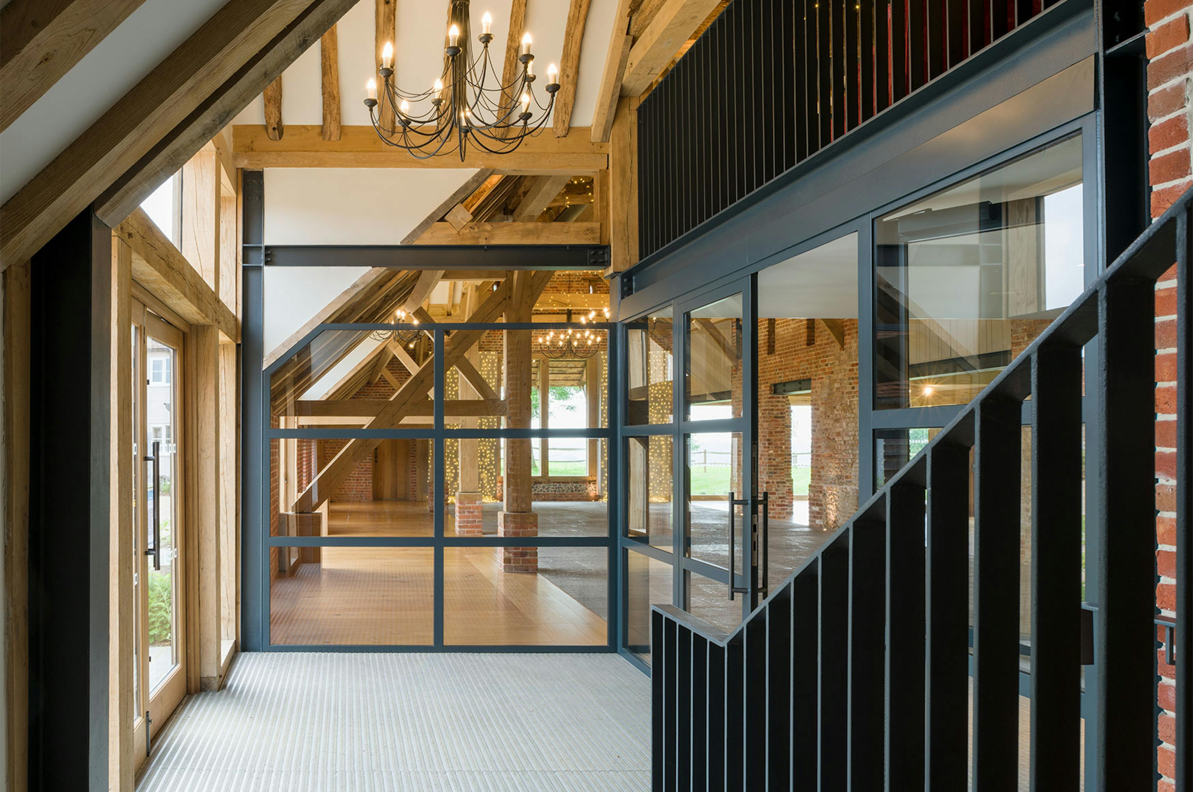The entrance of an oak framed wedding barn hall with steel doors