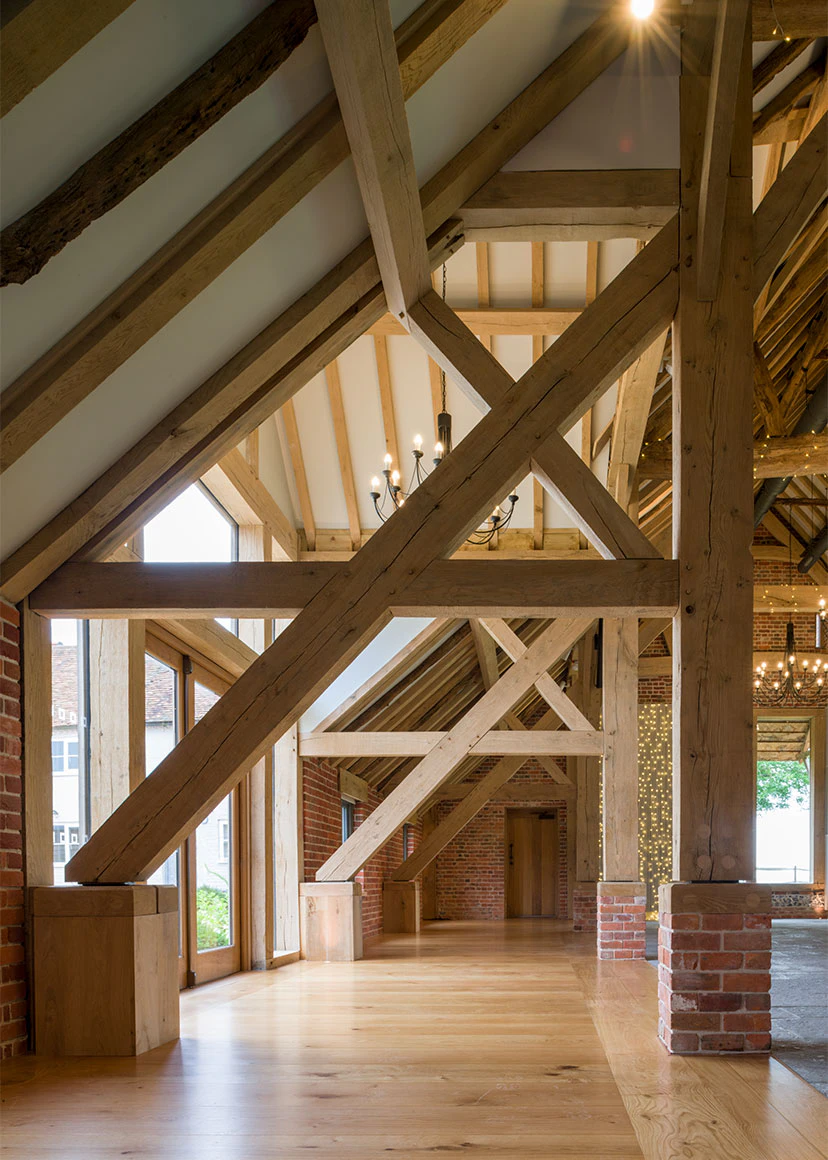 An oak framed wedding barn hall with oak posts on red brick post feet