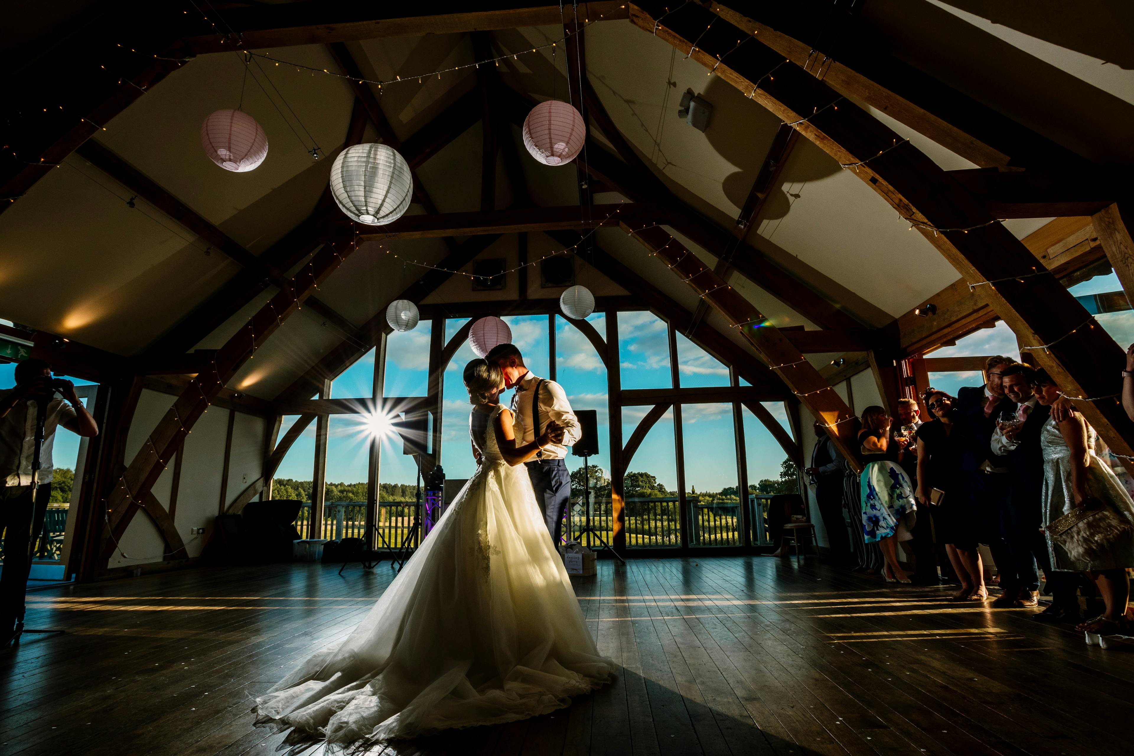 A bride and groom dancing in an oak 