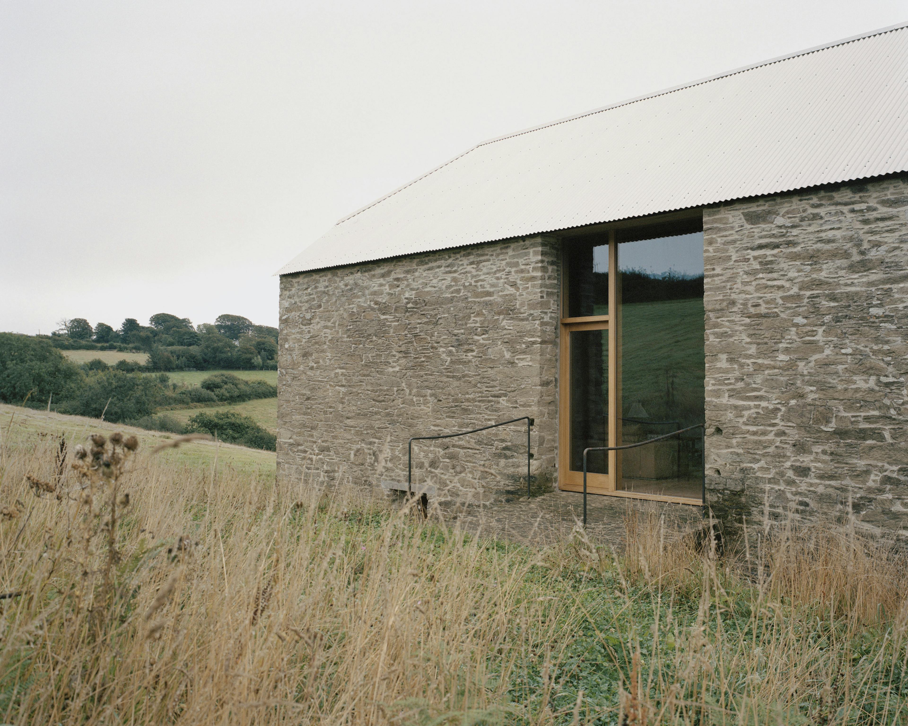 A renovated stone barn in a field
