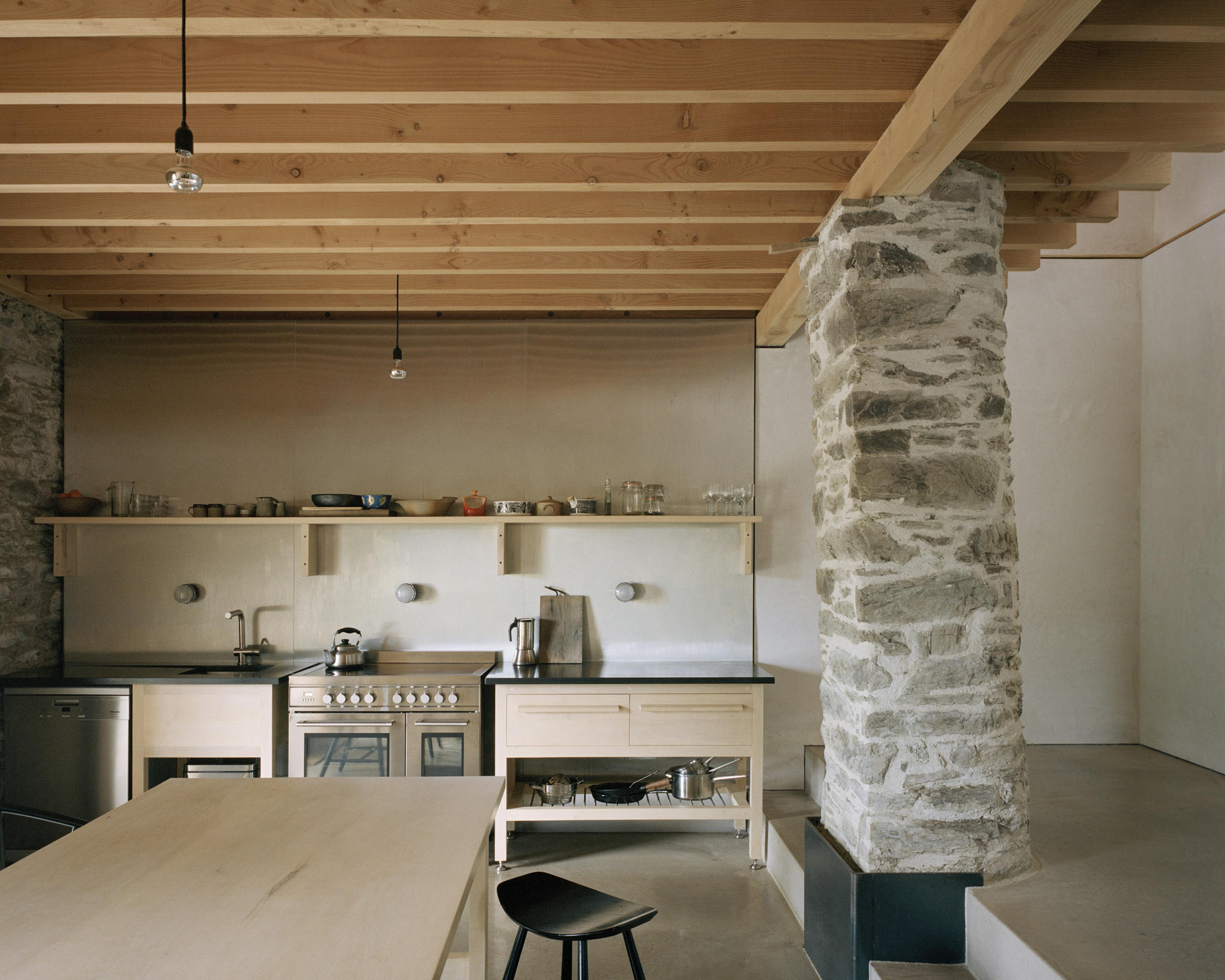 The kitchen of a renovated stone barn with a Douglas fir frame