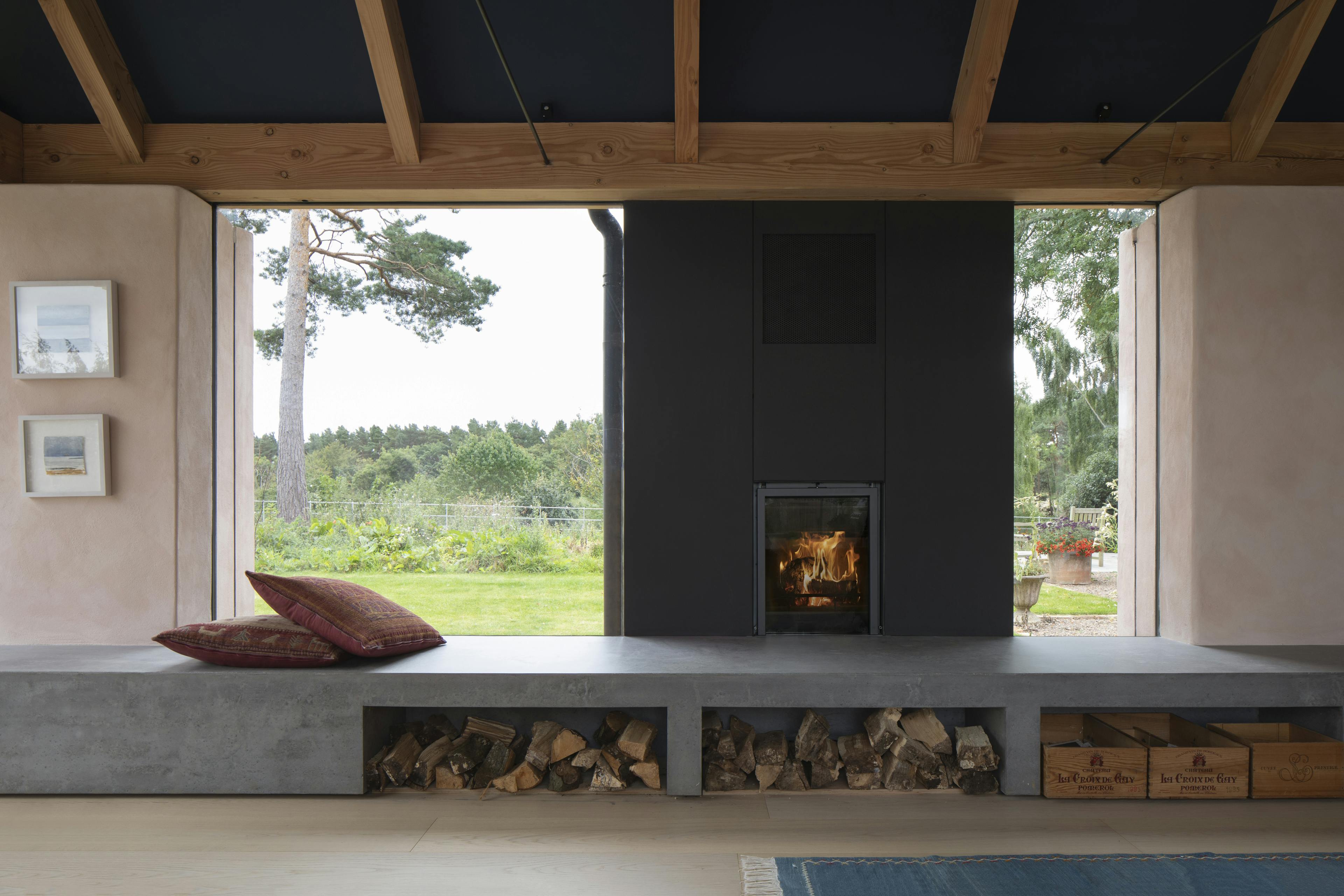 Douglas fir framed sitting room extension with log burner and window seats