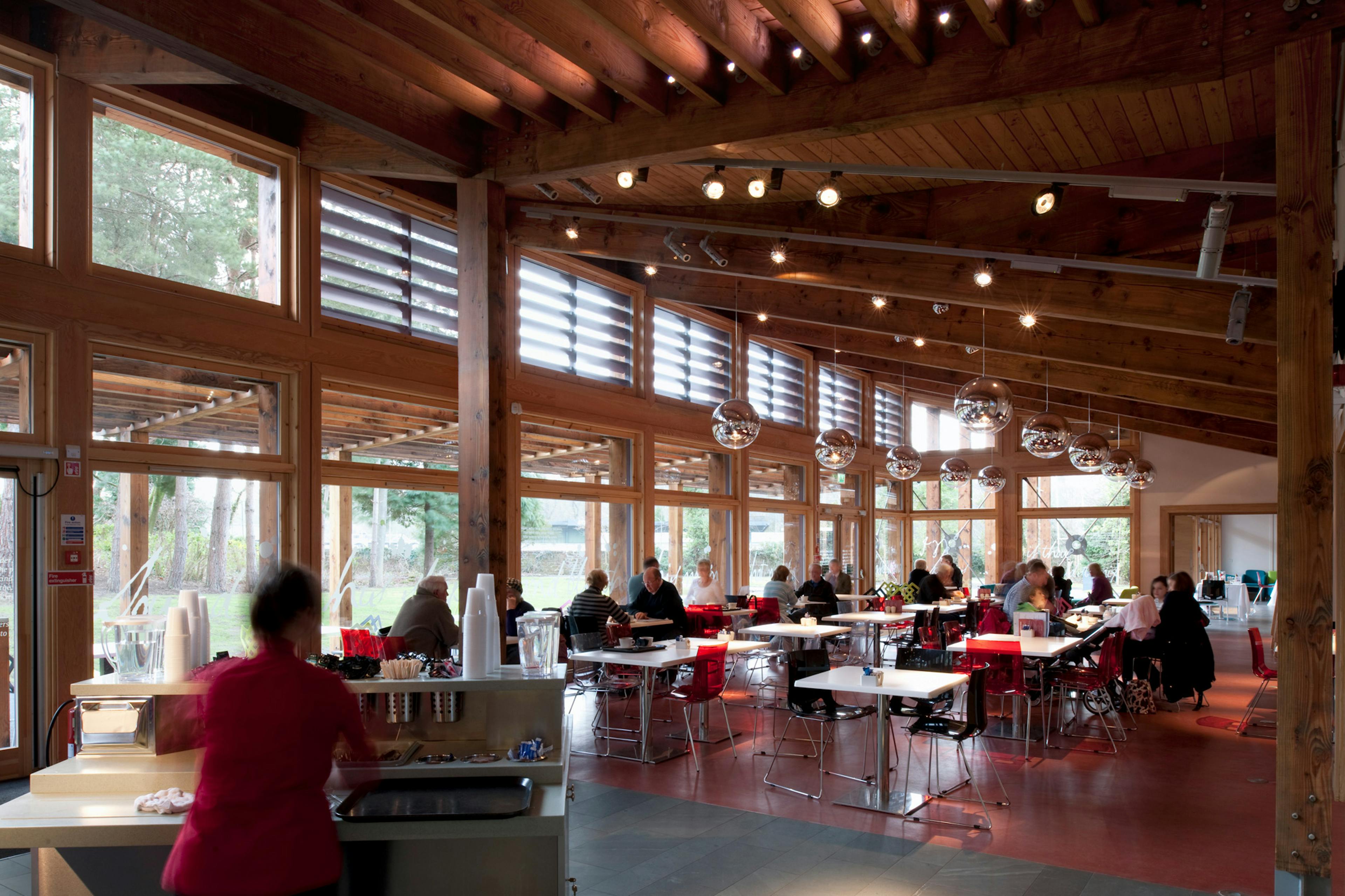 People in a Douglas fir framed cafe