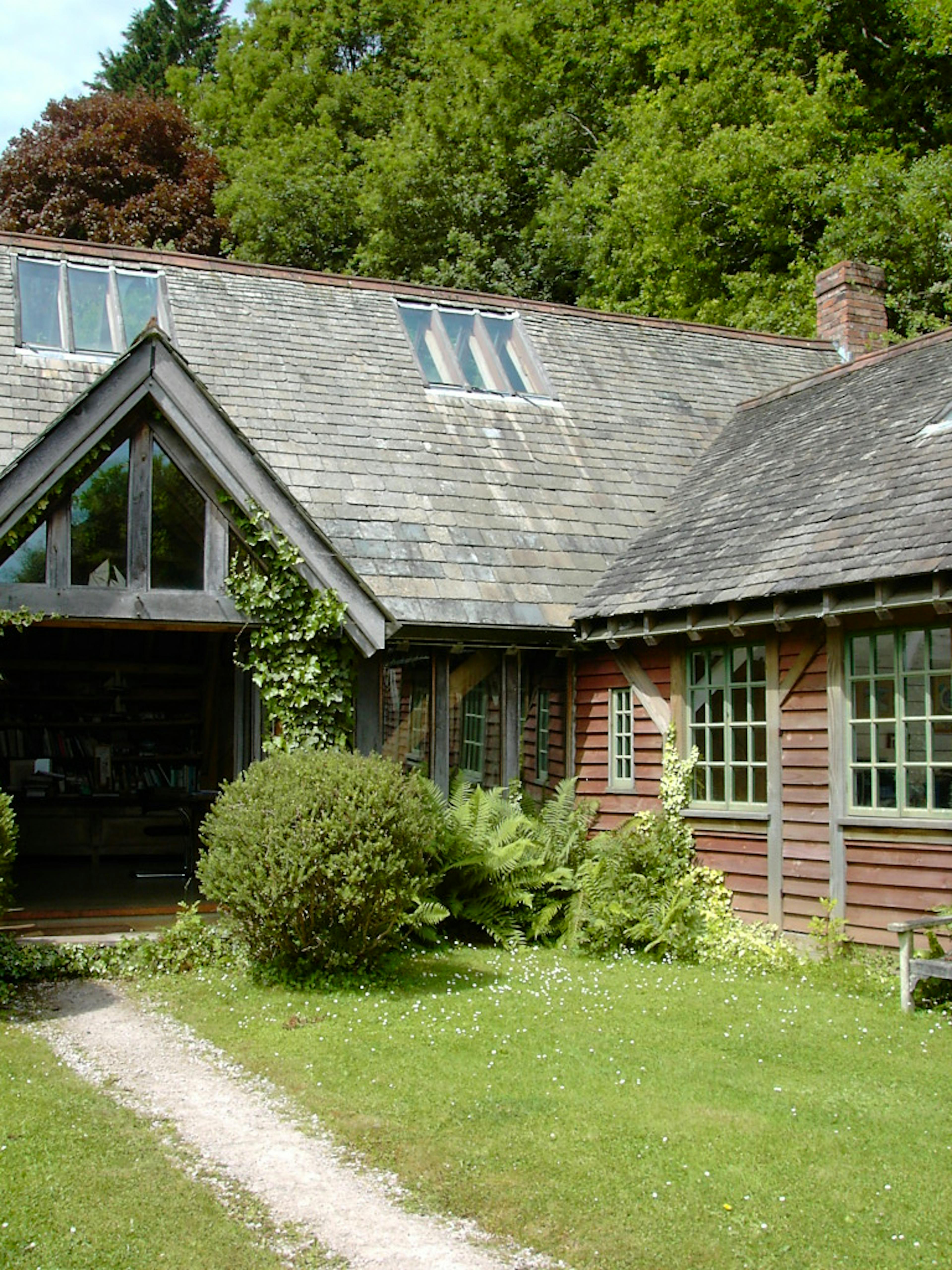 A timber clad oak framed home with an oak porch set in a pretty garden