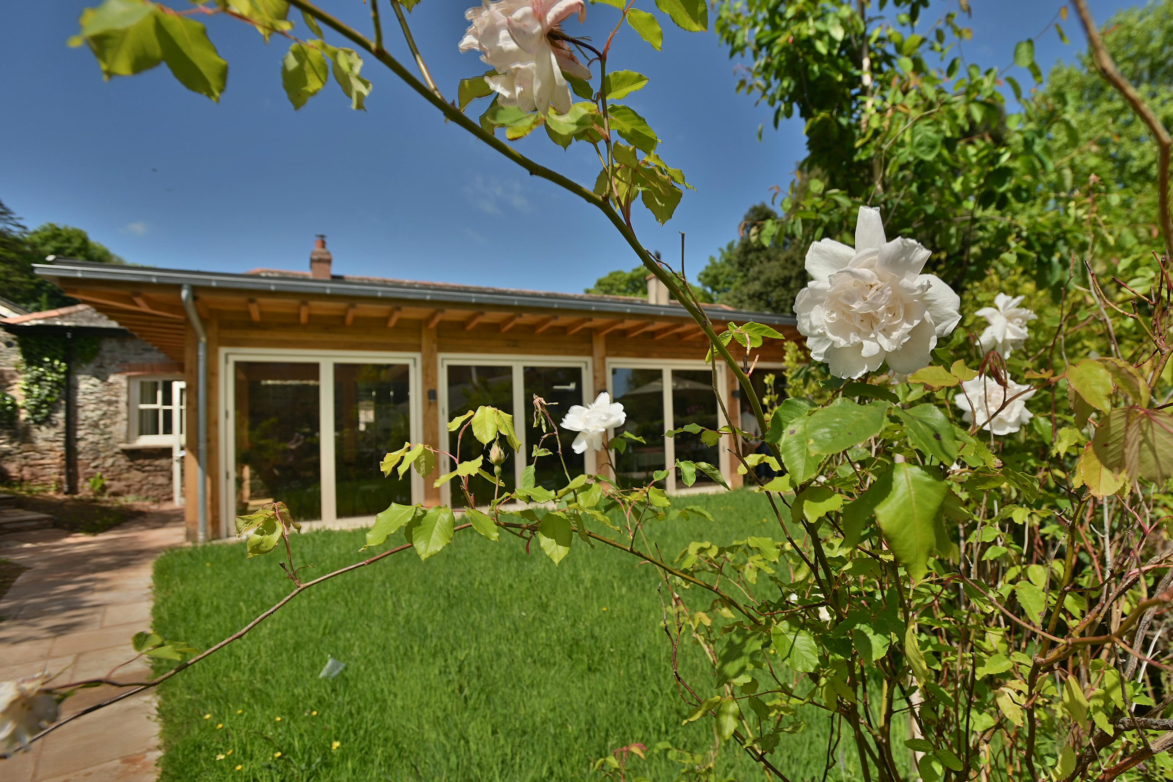A Douglas fir framed meditation room with a green lawn outside