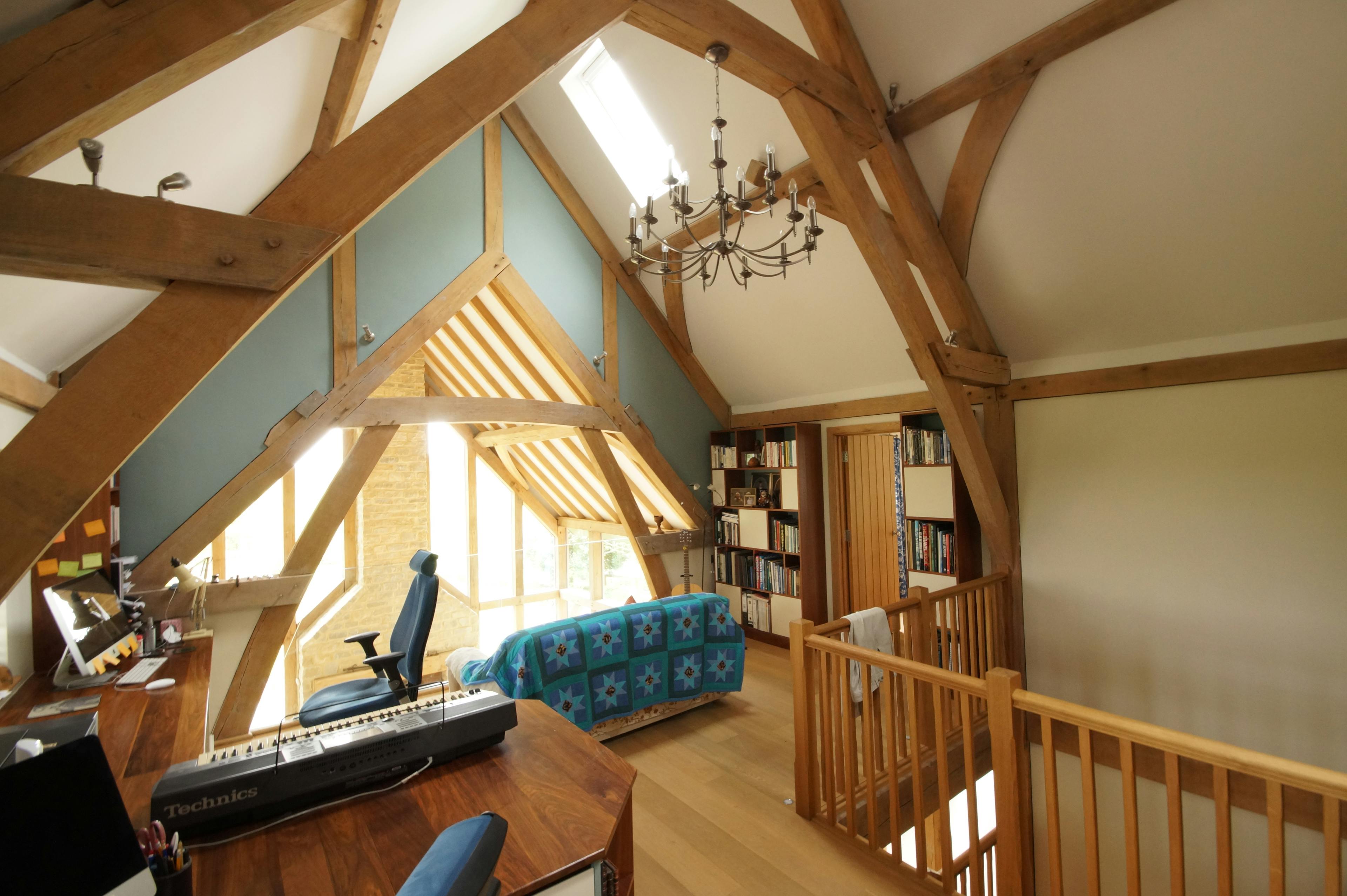 An oak framed mezzanine area with study and music studio