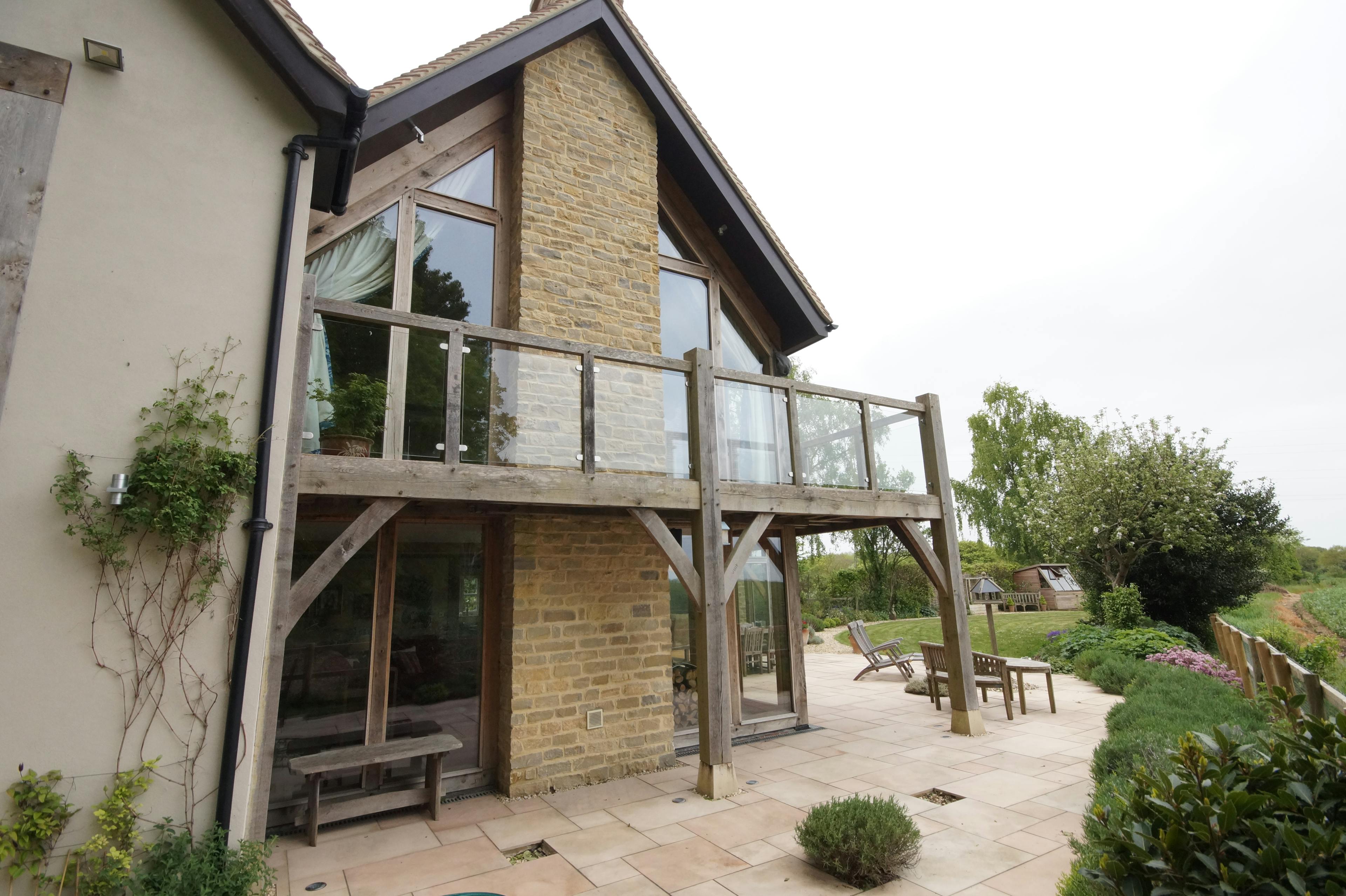 The rear of an oak framed home with oak balconies 