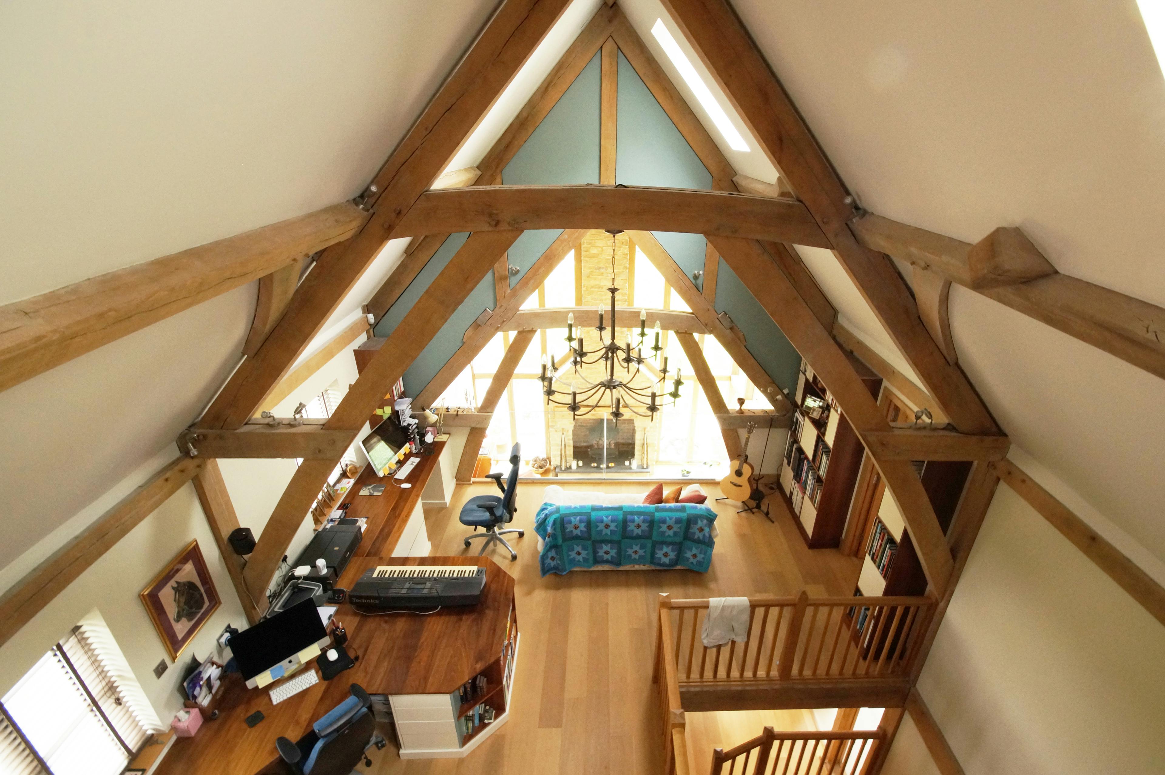 An oak framed mezzanine area with study and music studio