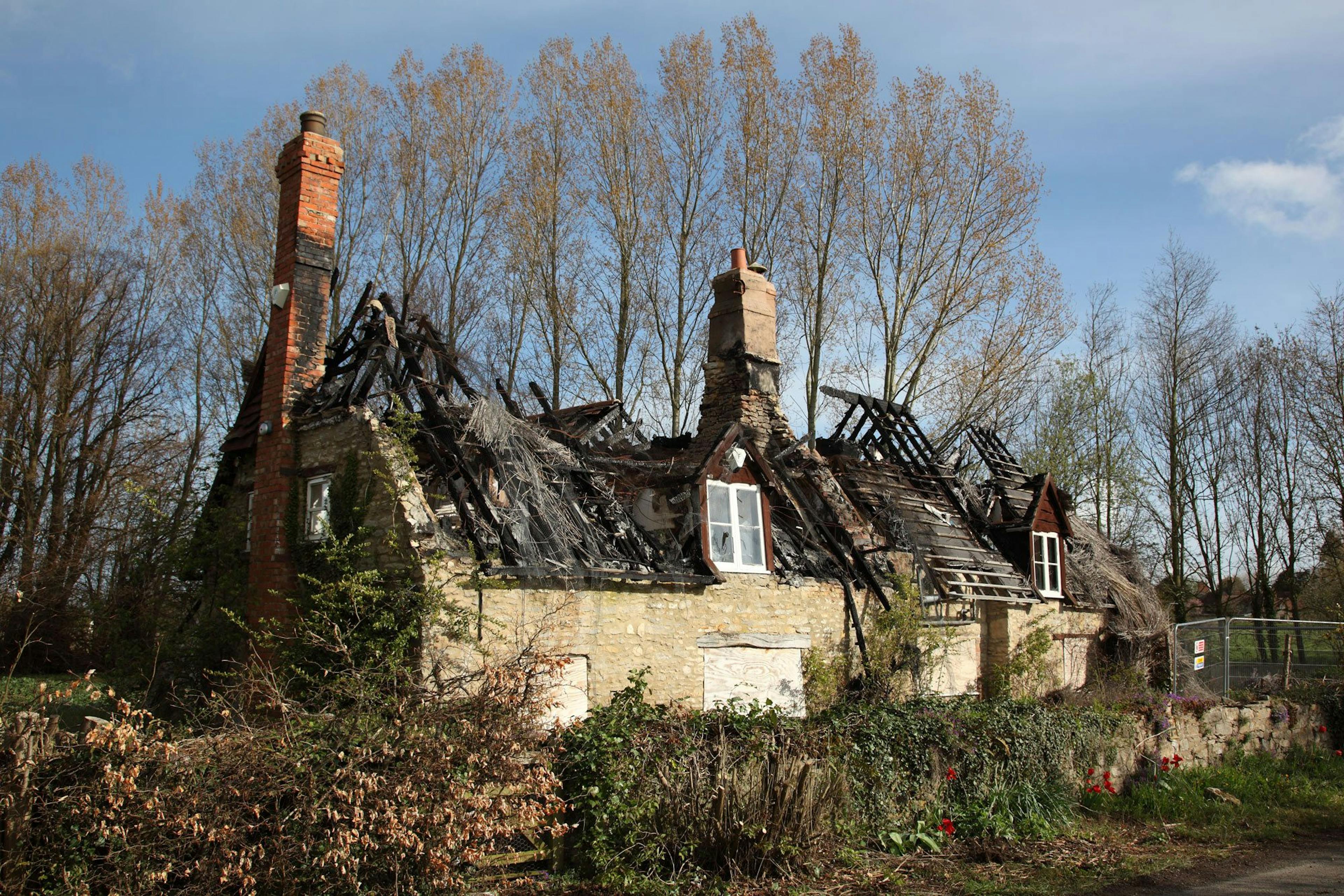 A fire-ravaged 16th-century thatched cottage