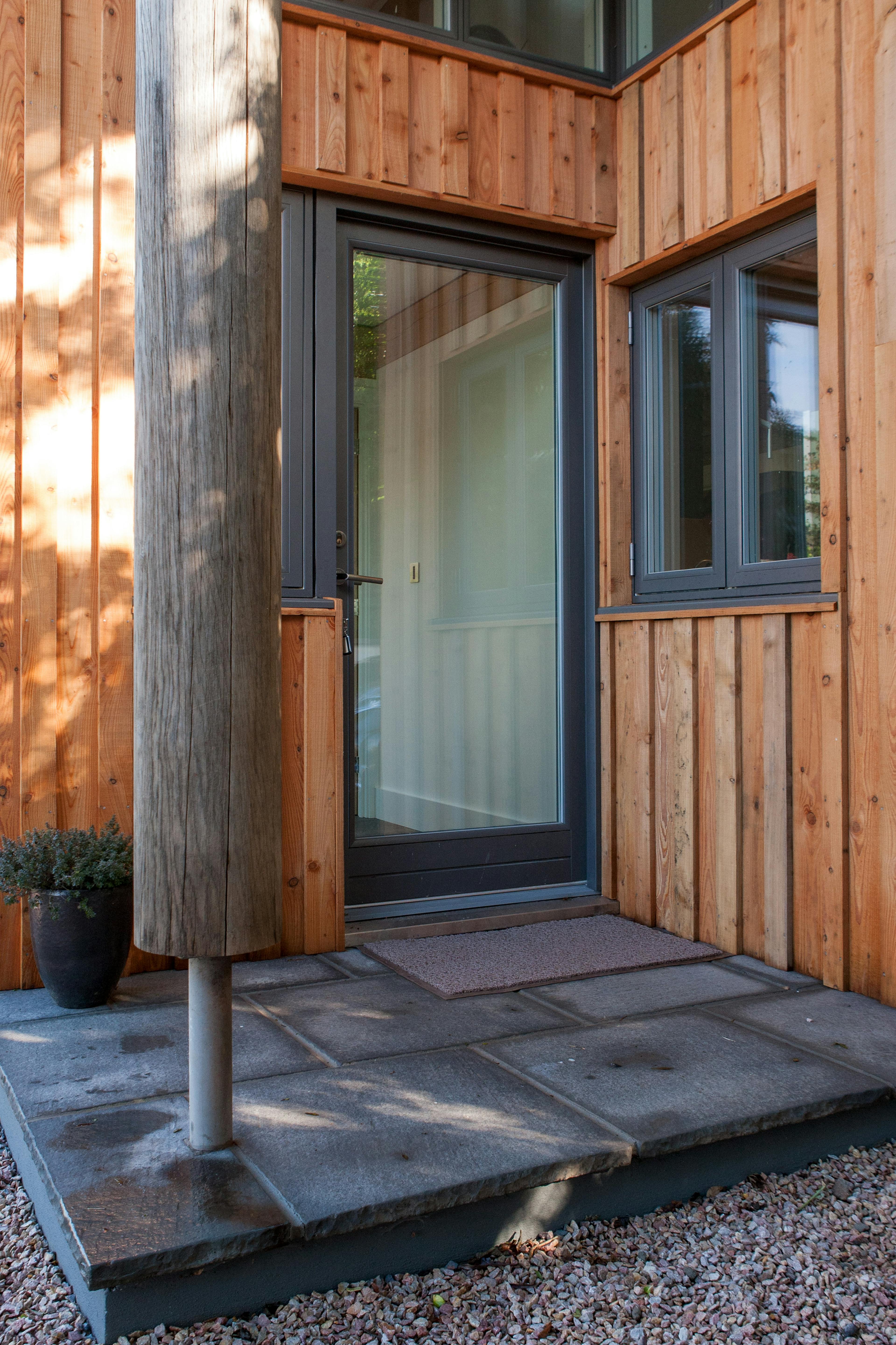 The timber clad entrance to a modern new build home 