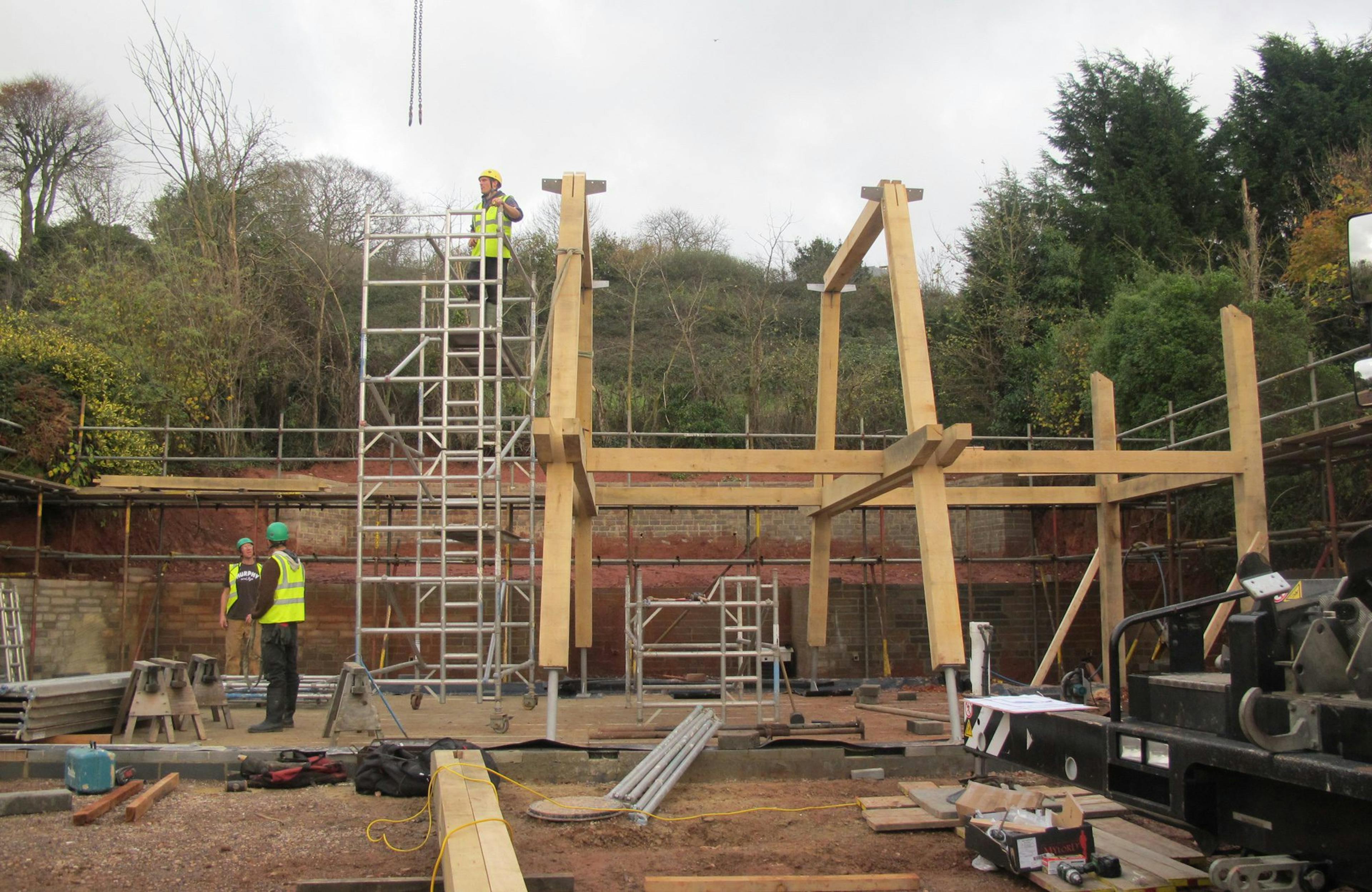 Installation of a modern oak and steel framed home on a construction site