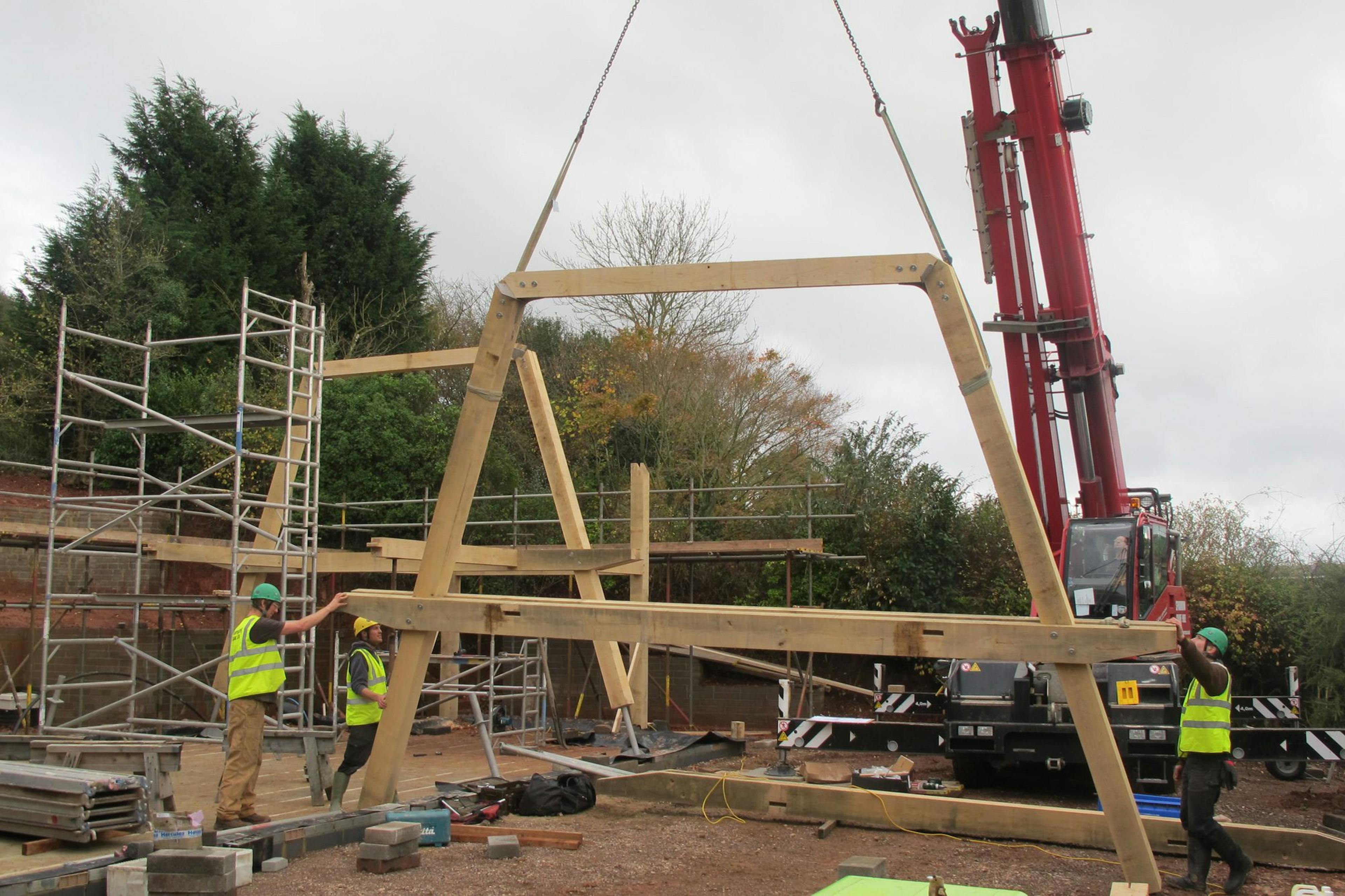 Installation of a modern oak and steel framed home on a construction site