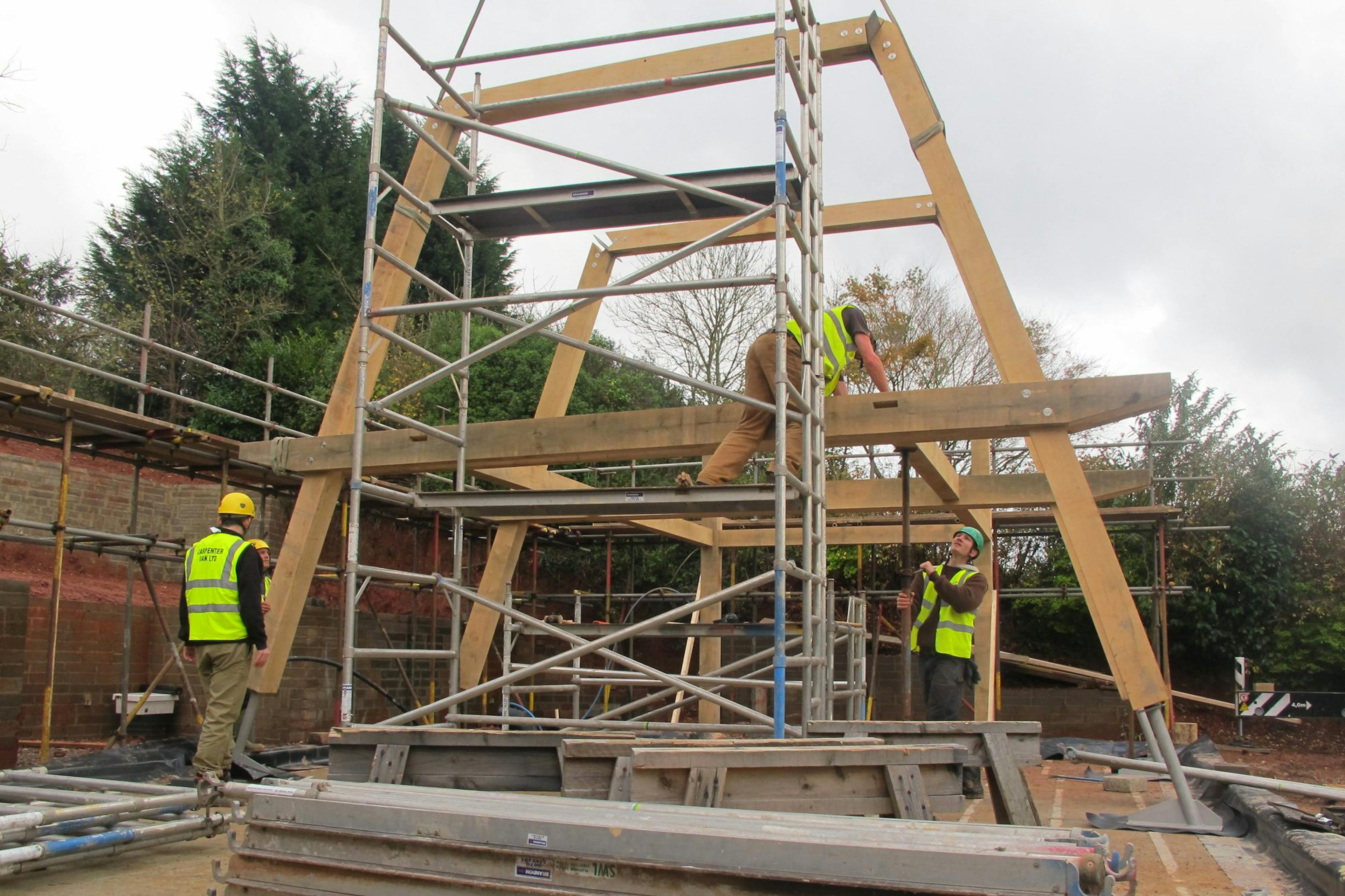 Installation of a modern oak and steel framed home on a construction site