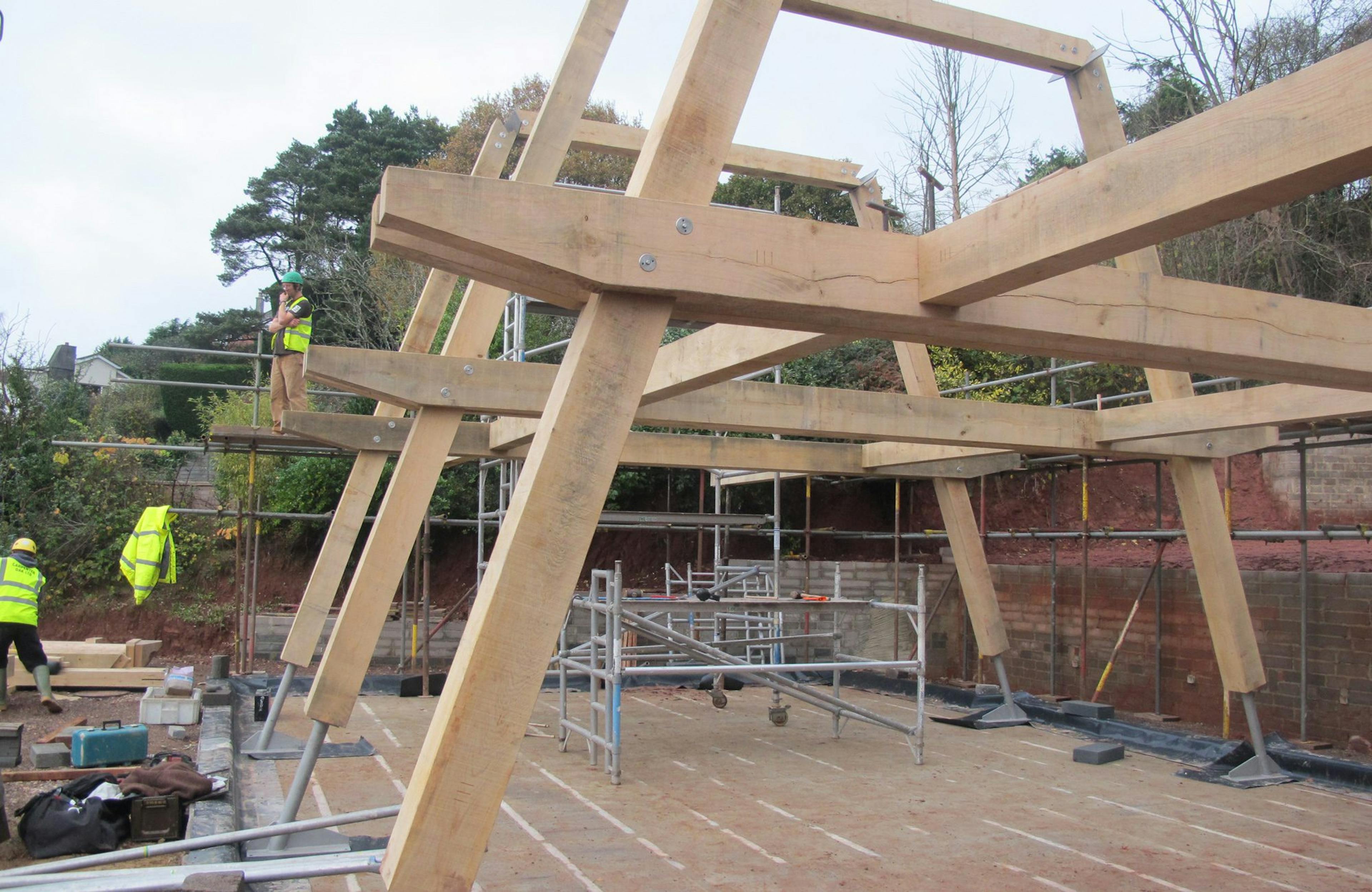 Installation of a modern oak and steel framed home on a construction site