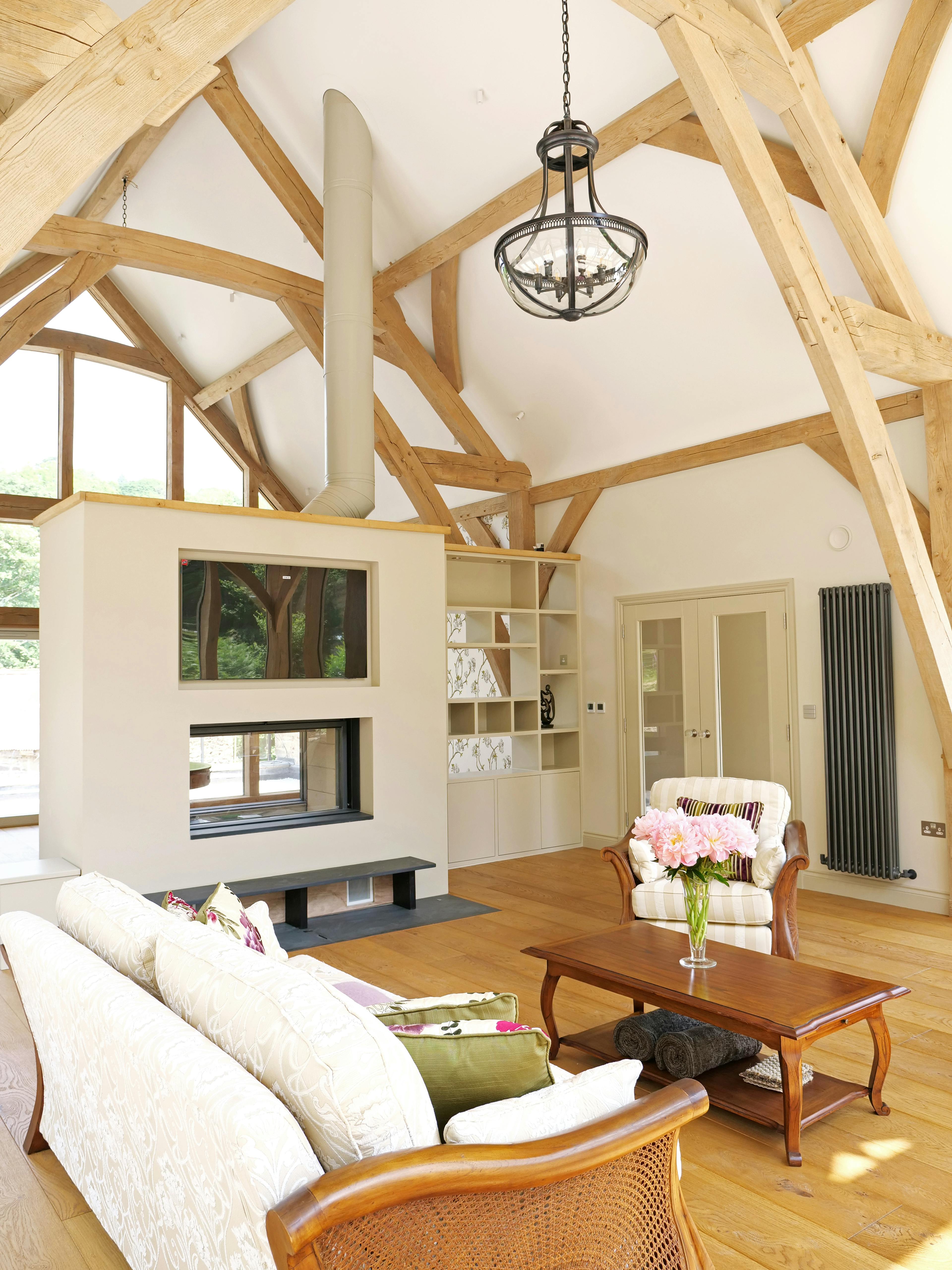An oak framed extension with a sitting room and fire place