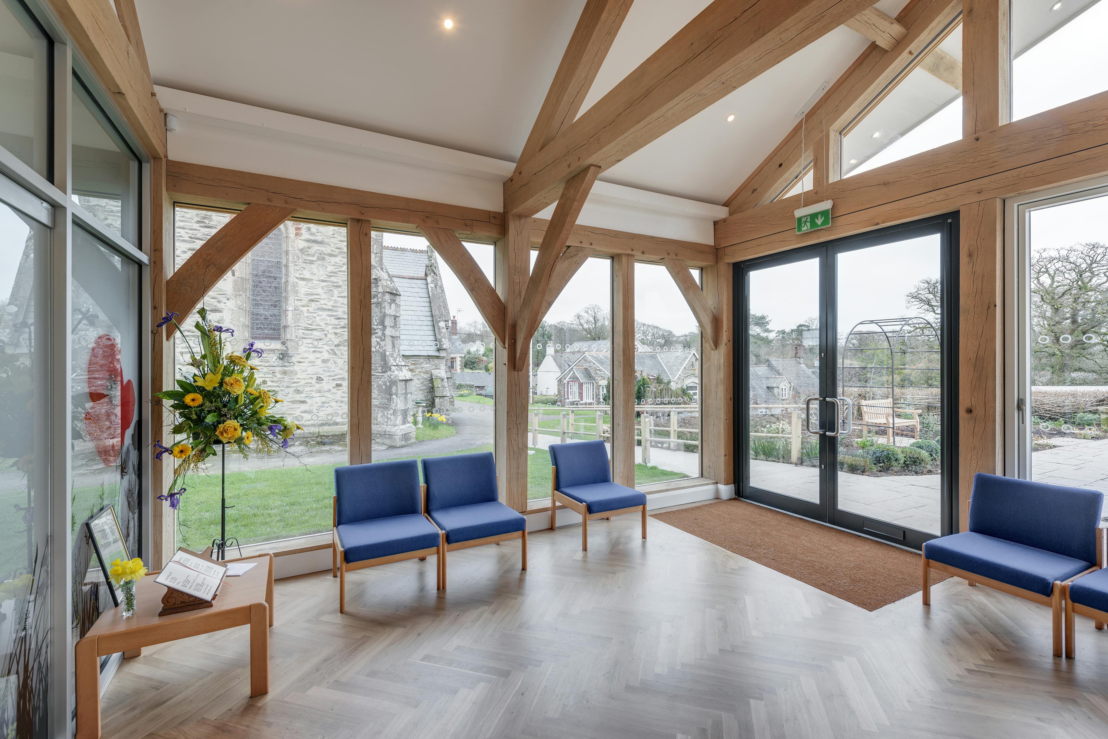 The entrance to an oak framed hall with parquet flooring