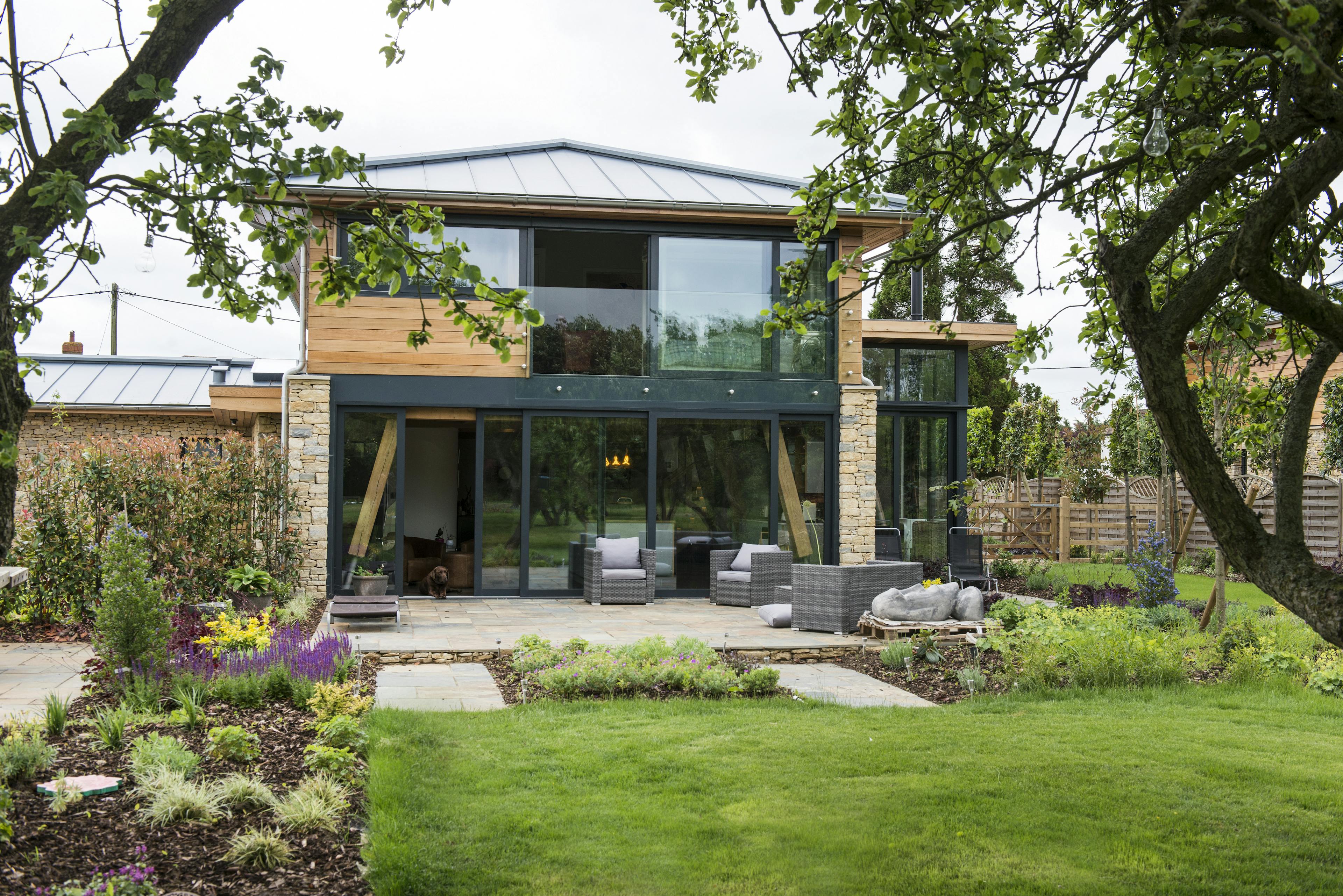 A modern two storey oak framed home with glazing, set in a landscaped garden