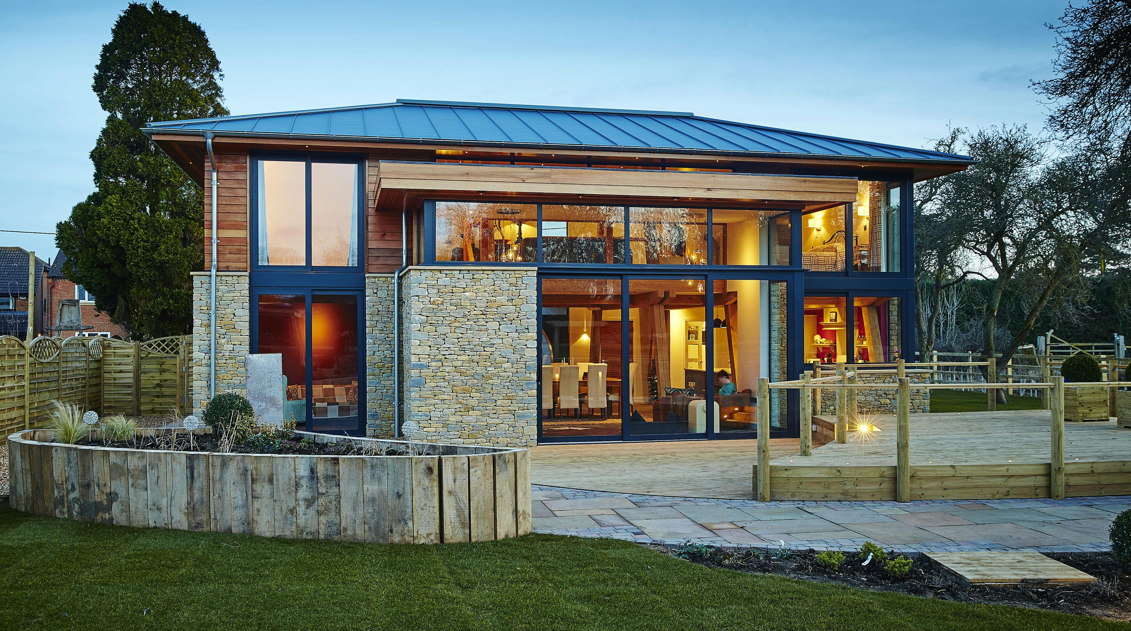 A modern two storey oak framed home with glazing, set in a landscaped garden