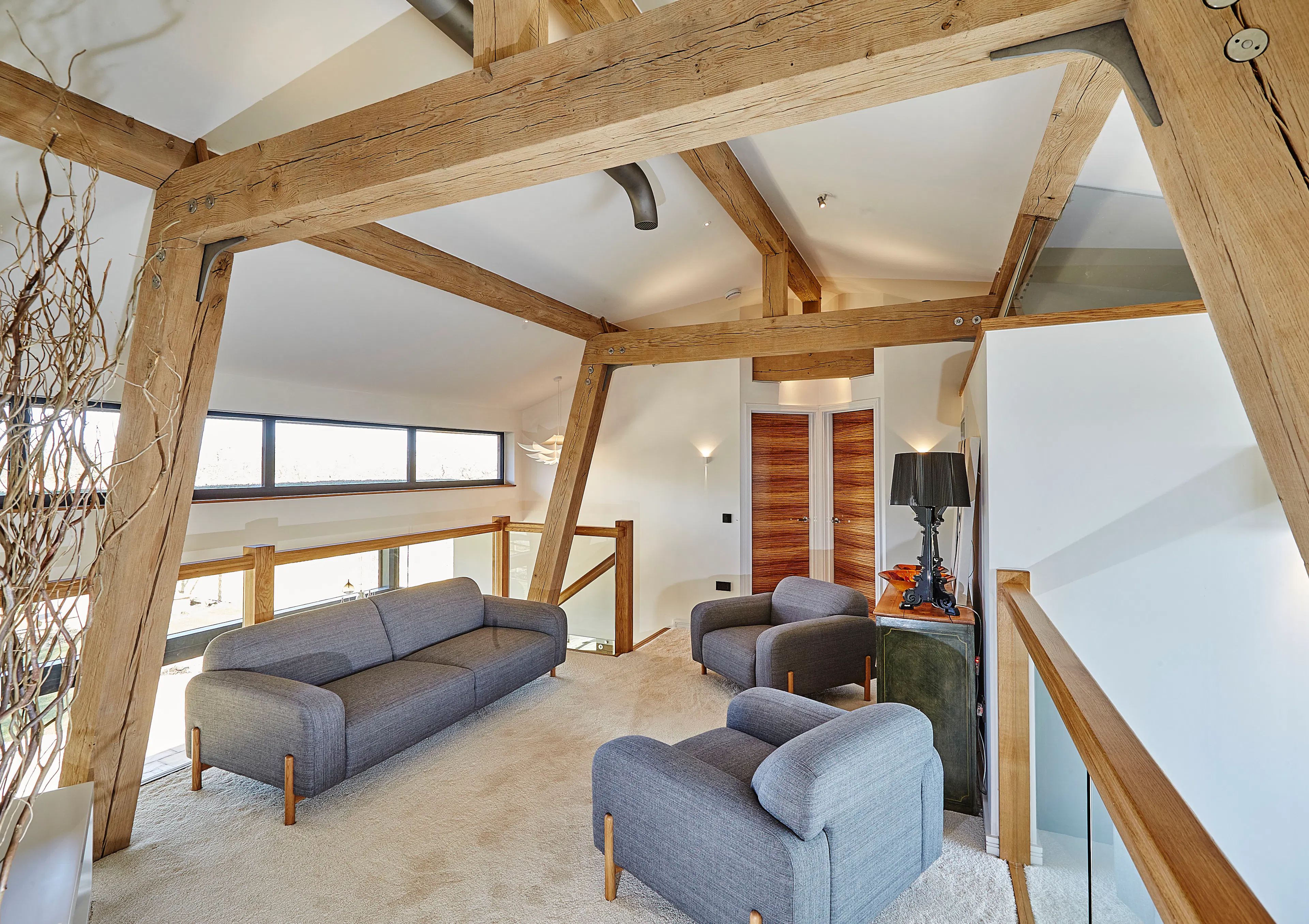 An oak framed mezzanine sitting area with sofas
