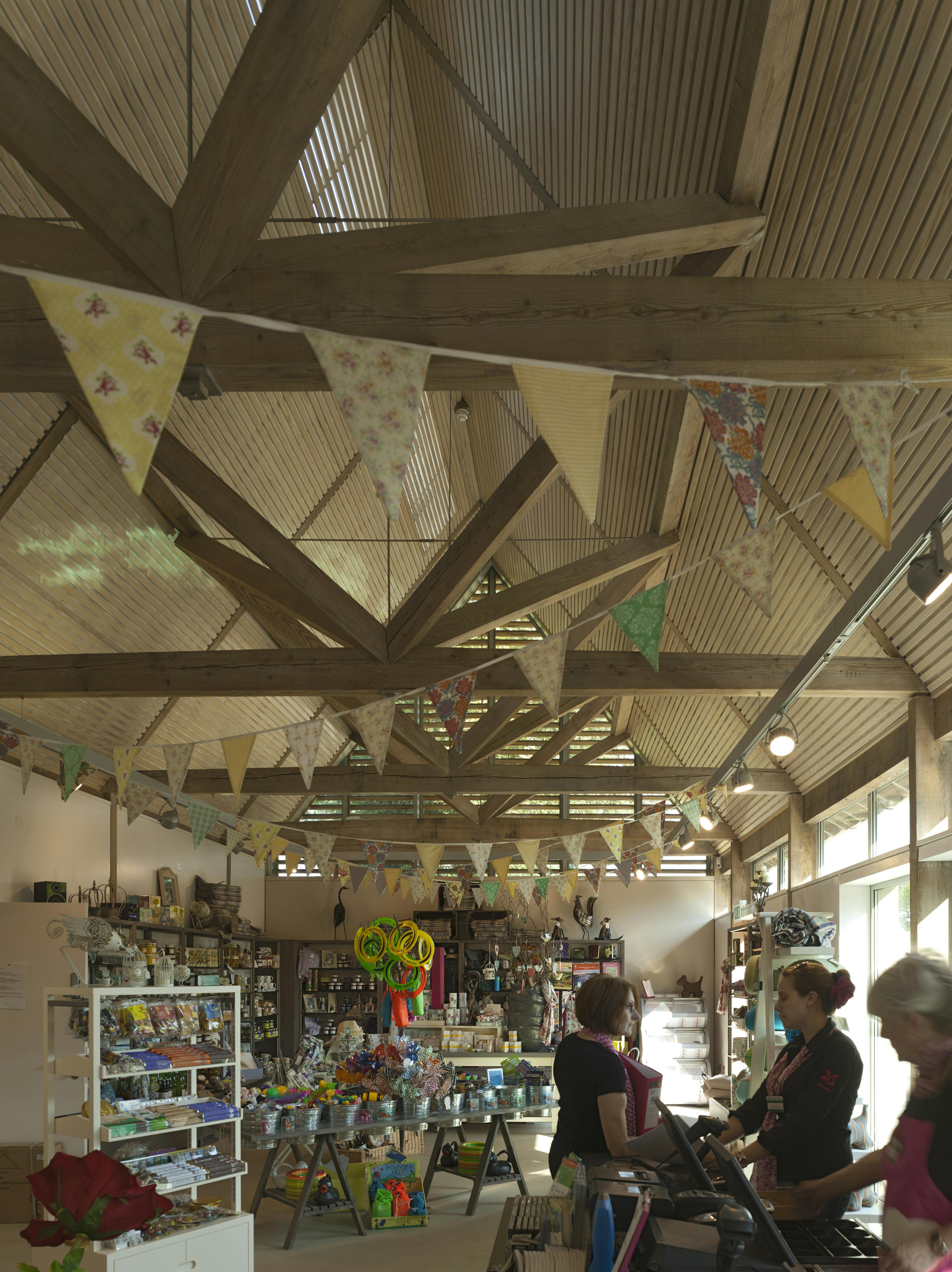 Guests inside a visitors centre made with a diagrid roof constructed from larch