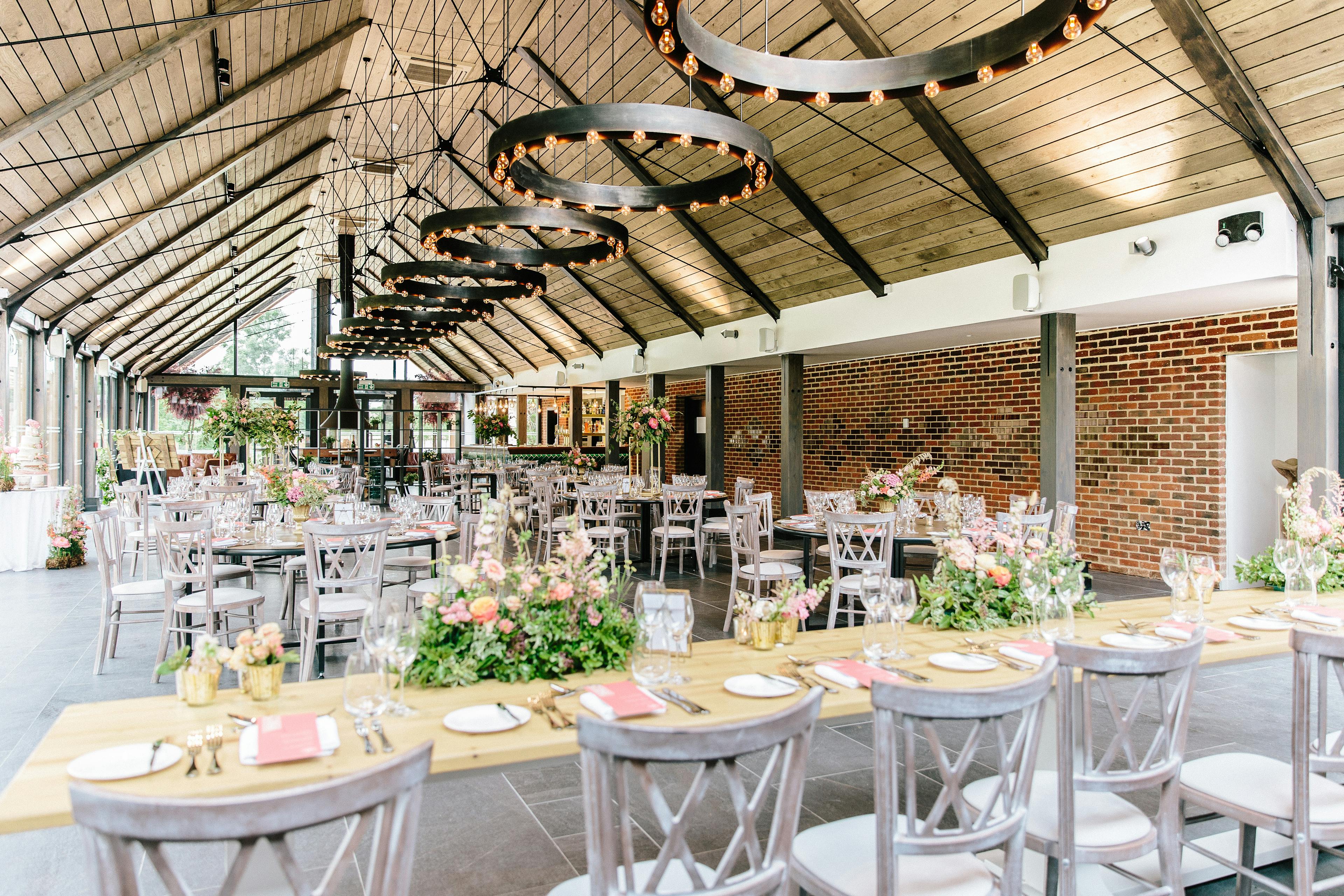 Tables laid and ready for guests in a timber white spruce glulam wedding barn