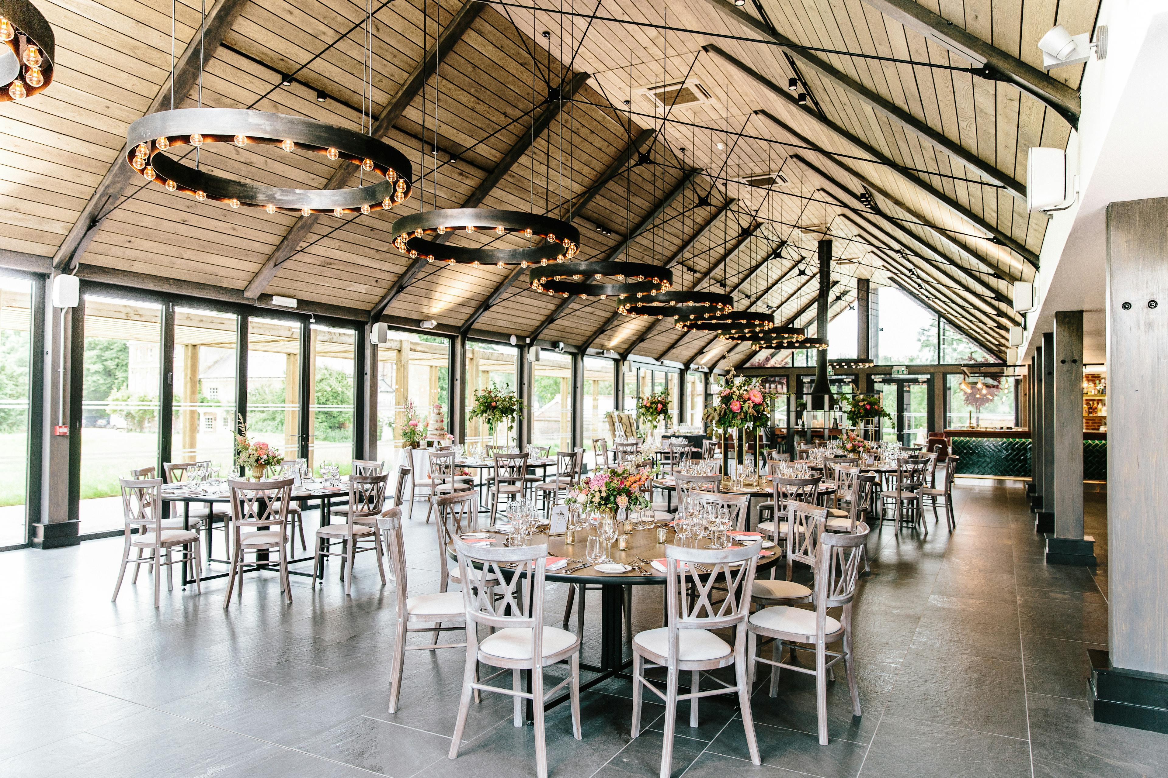 Tables laid and ready for guests in a timber white spruce glulam wedding barn