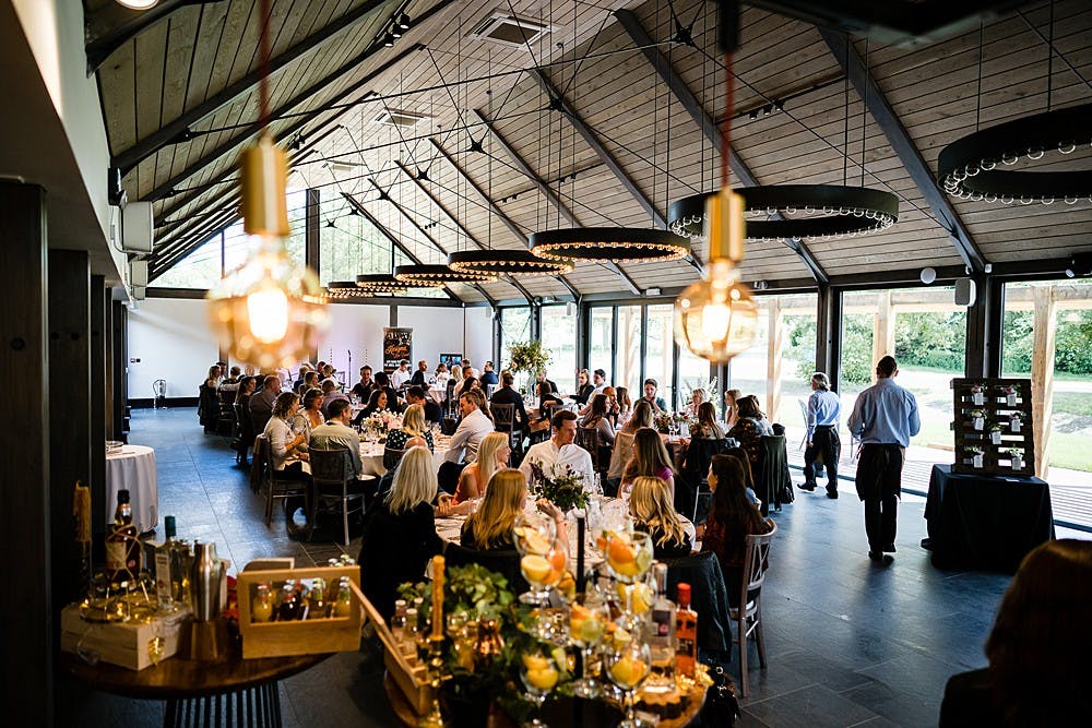 Guests in a timber white spruce glulam wedding barn