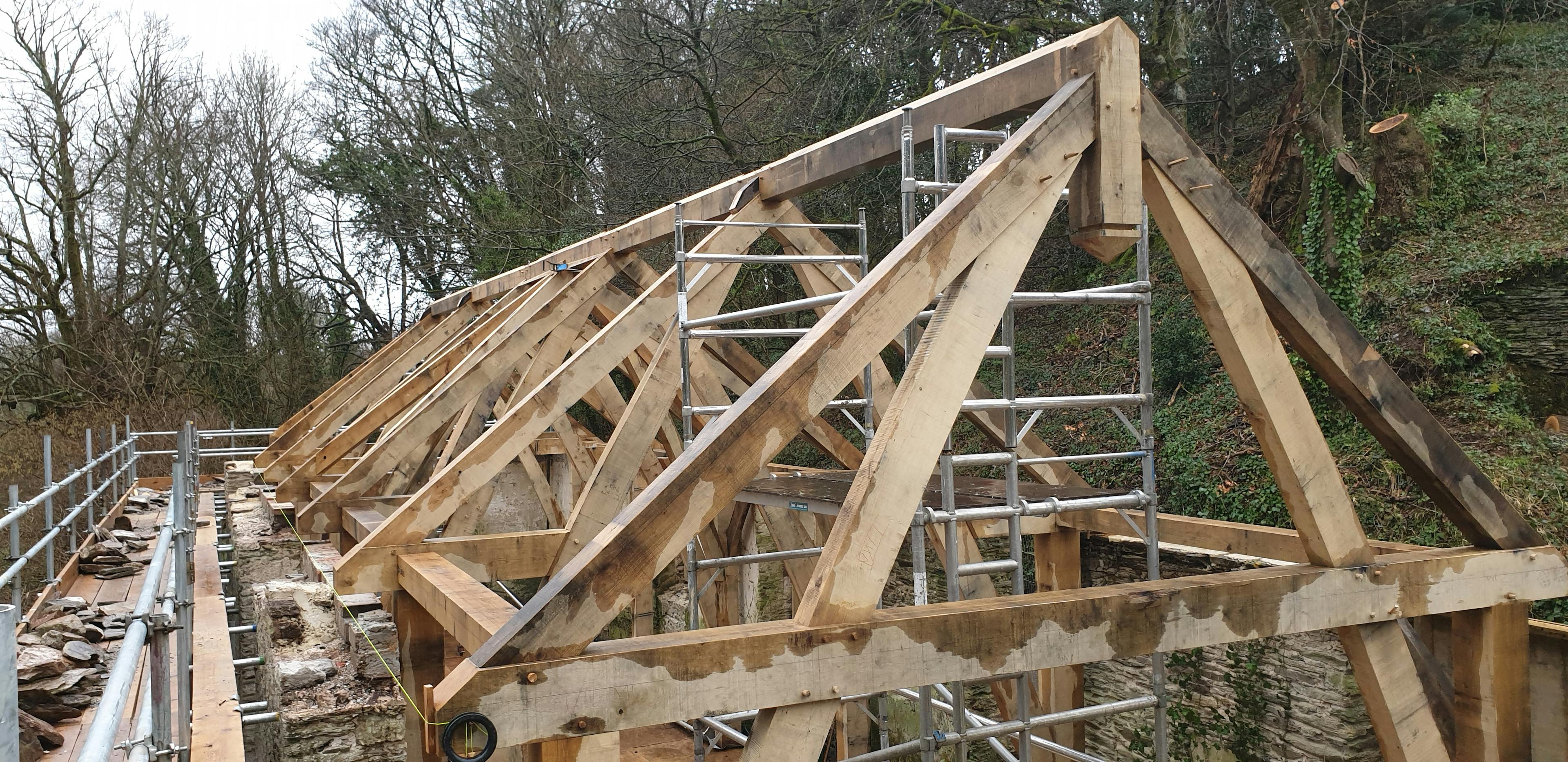 Exterior view of oak sling-brace trusses installed on-site