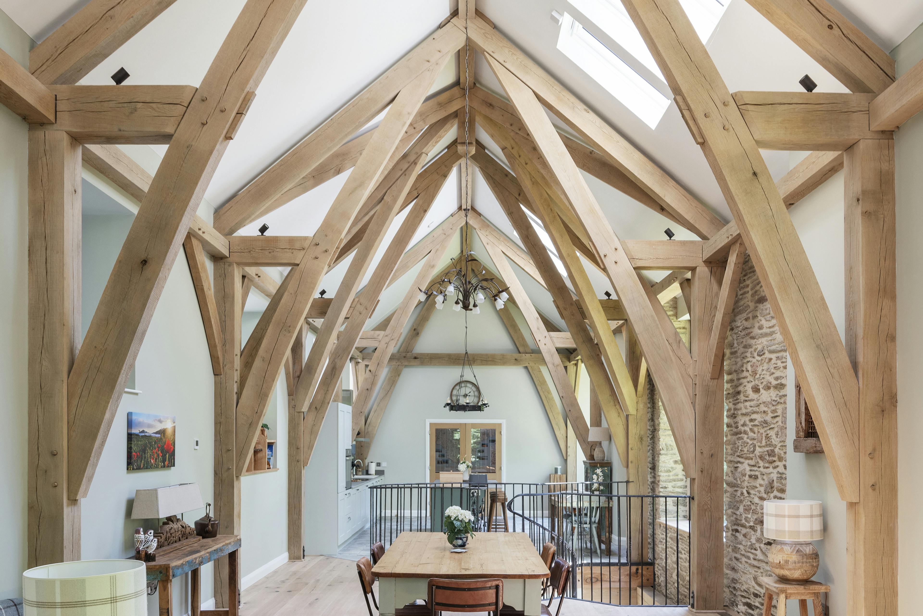 Vaulted oak framed ceiling with sofa and dining area