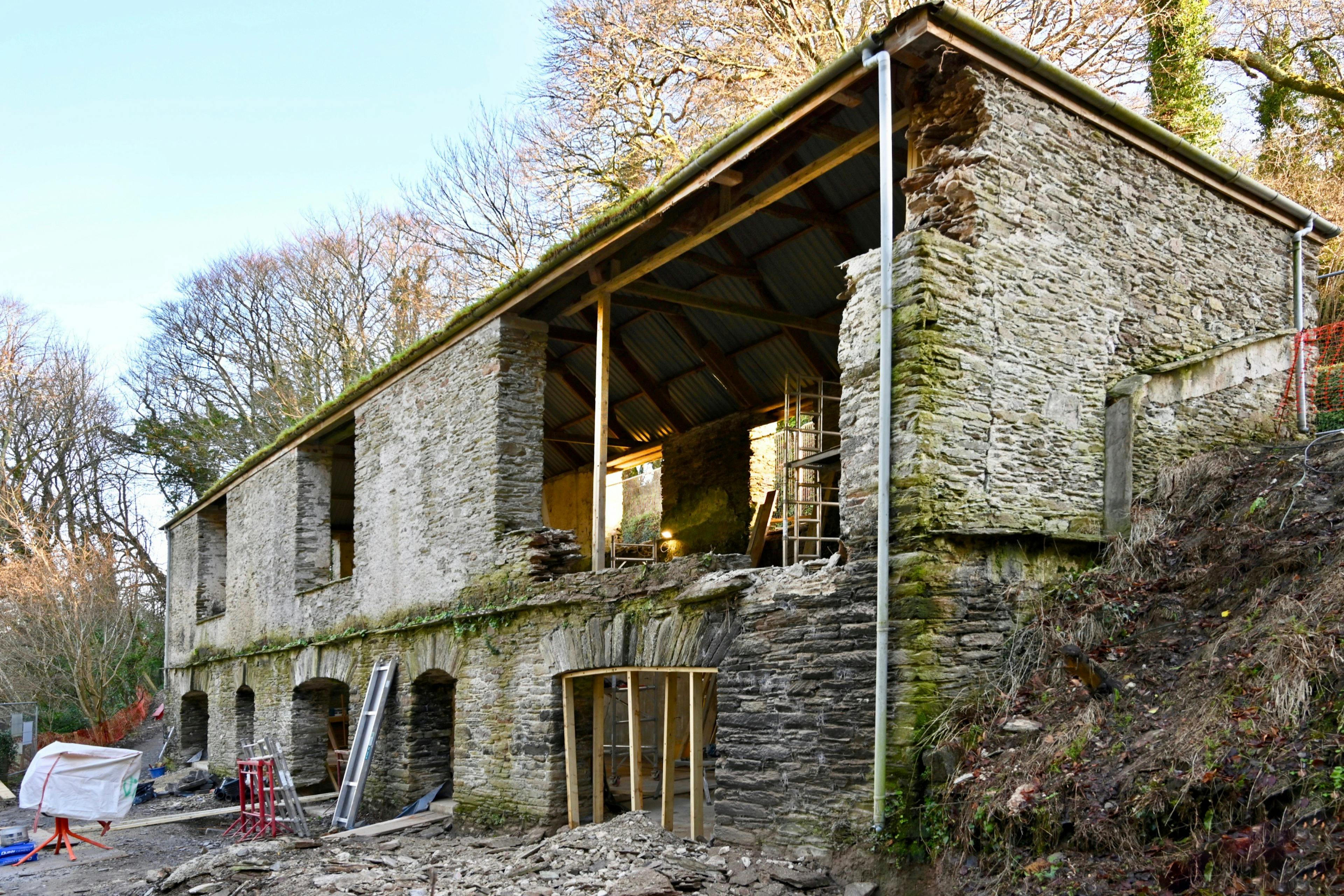Derelict stone barn being demolished and rebuilt into a modern family home