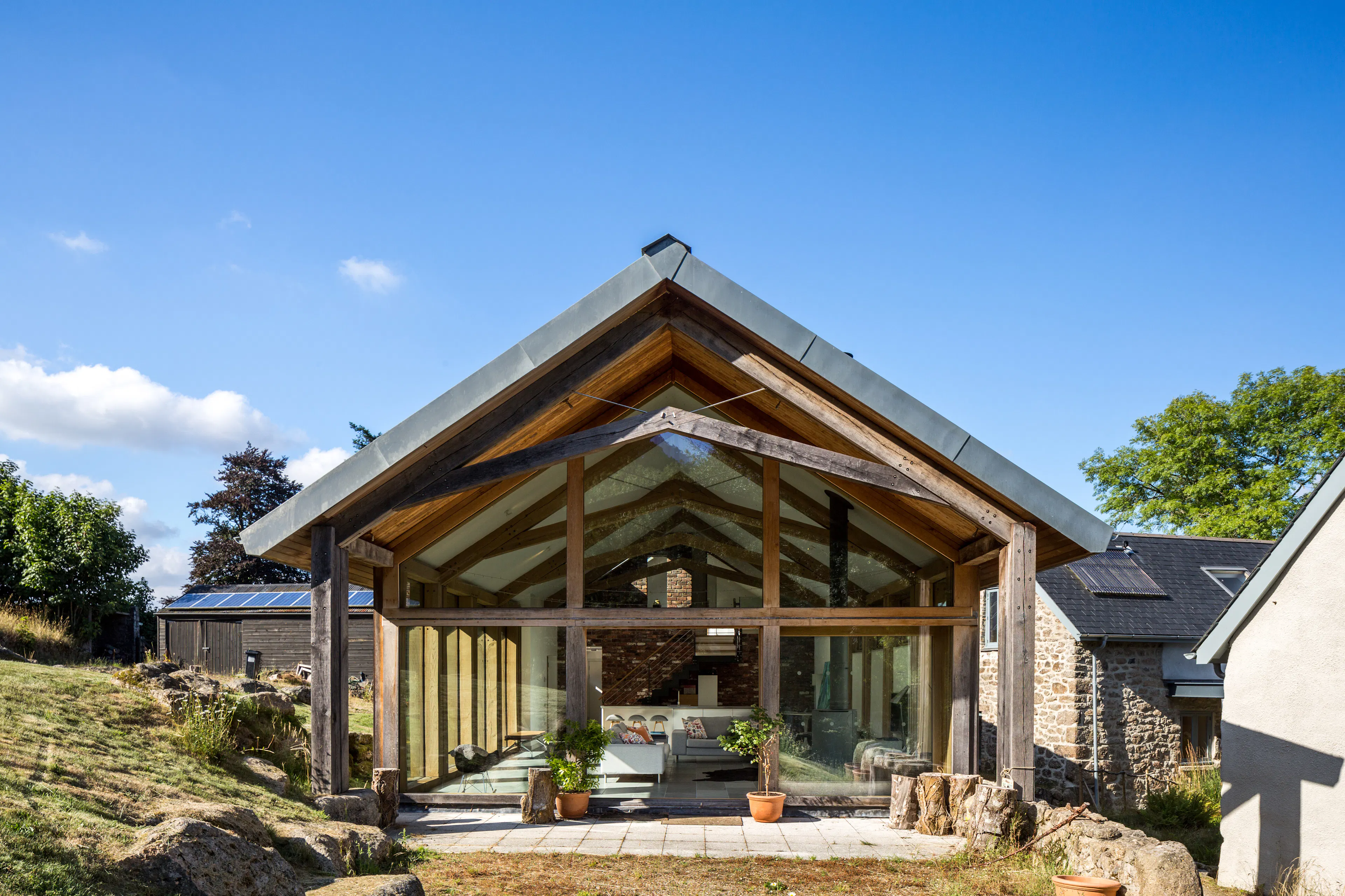 Exterior view of an oak frame extension to a stone farmhouse cottage