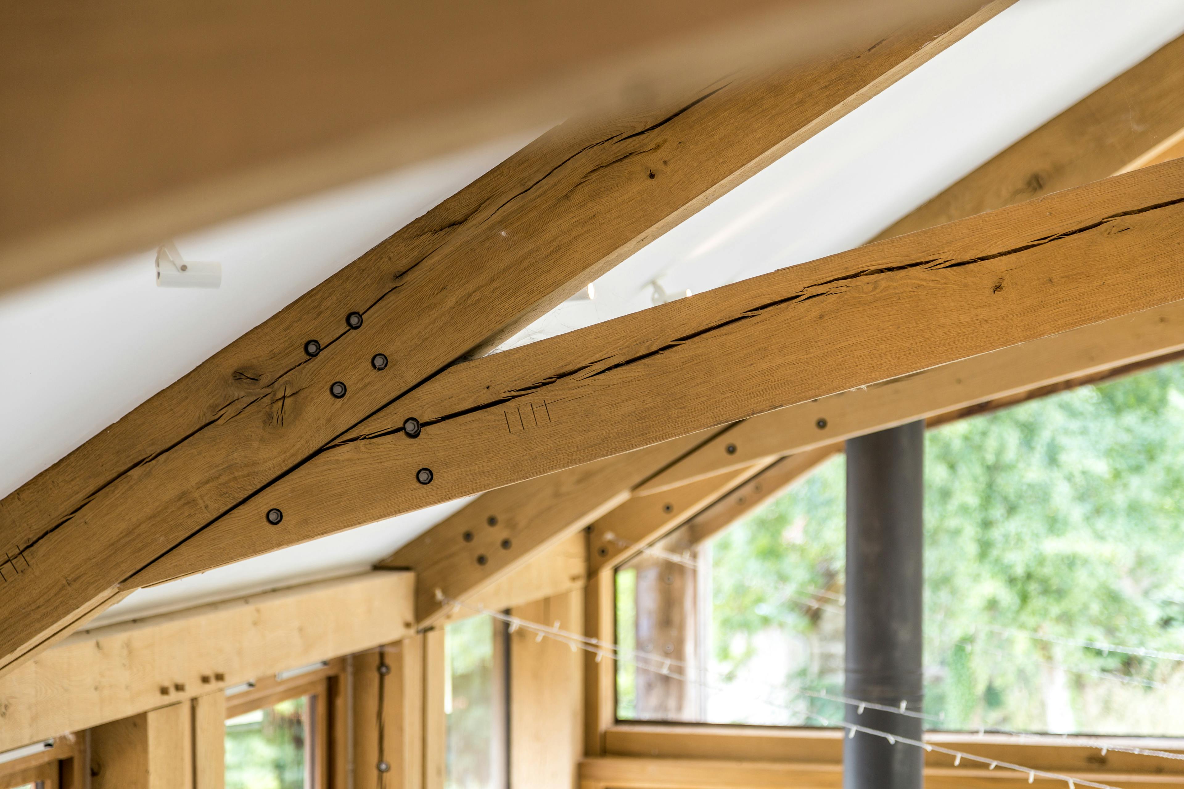 Close-up view of steel fixings within a structural oak-framed truss