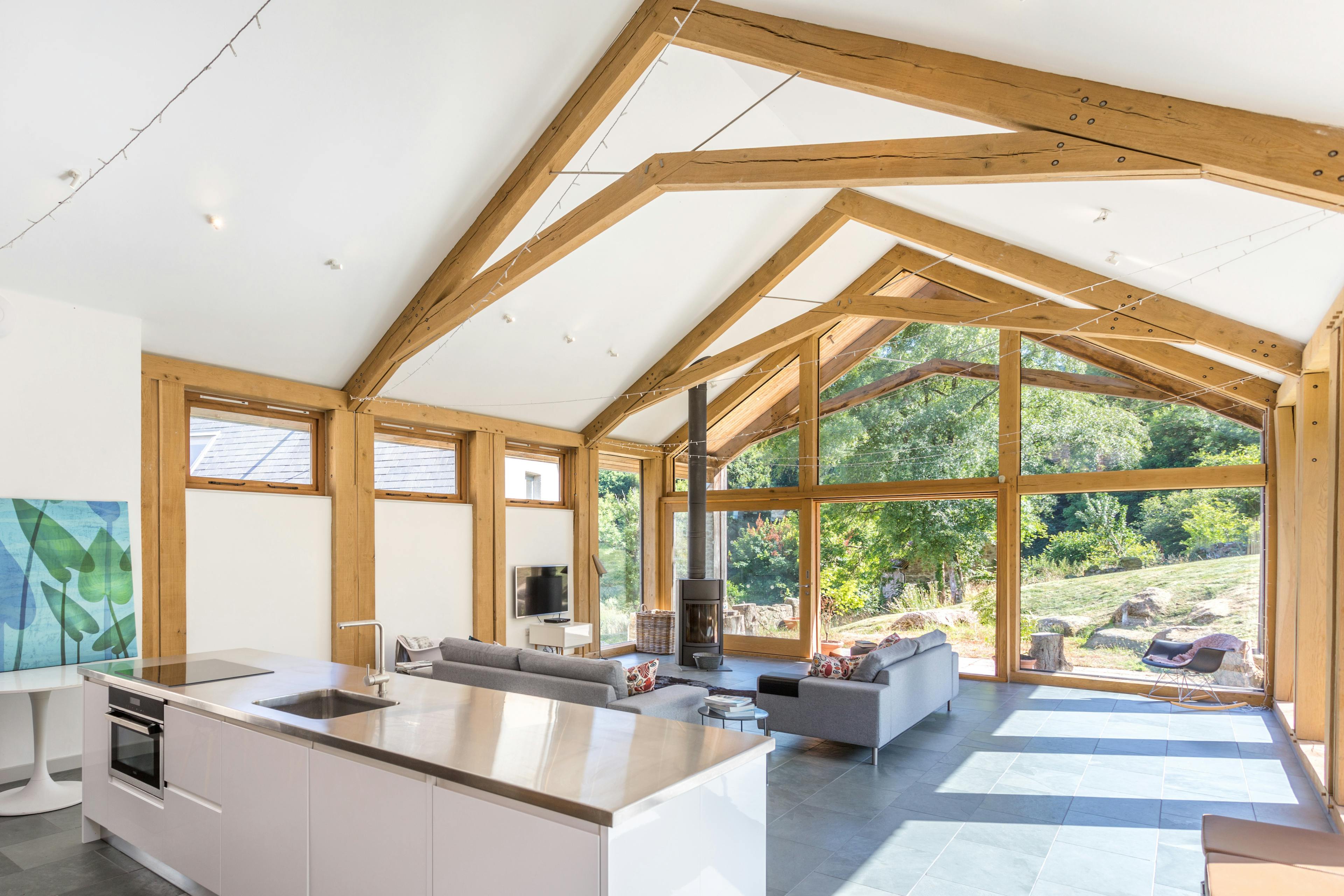 An open-plan annex featuring a contemporary, minimalist kitchen and living area