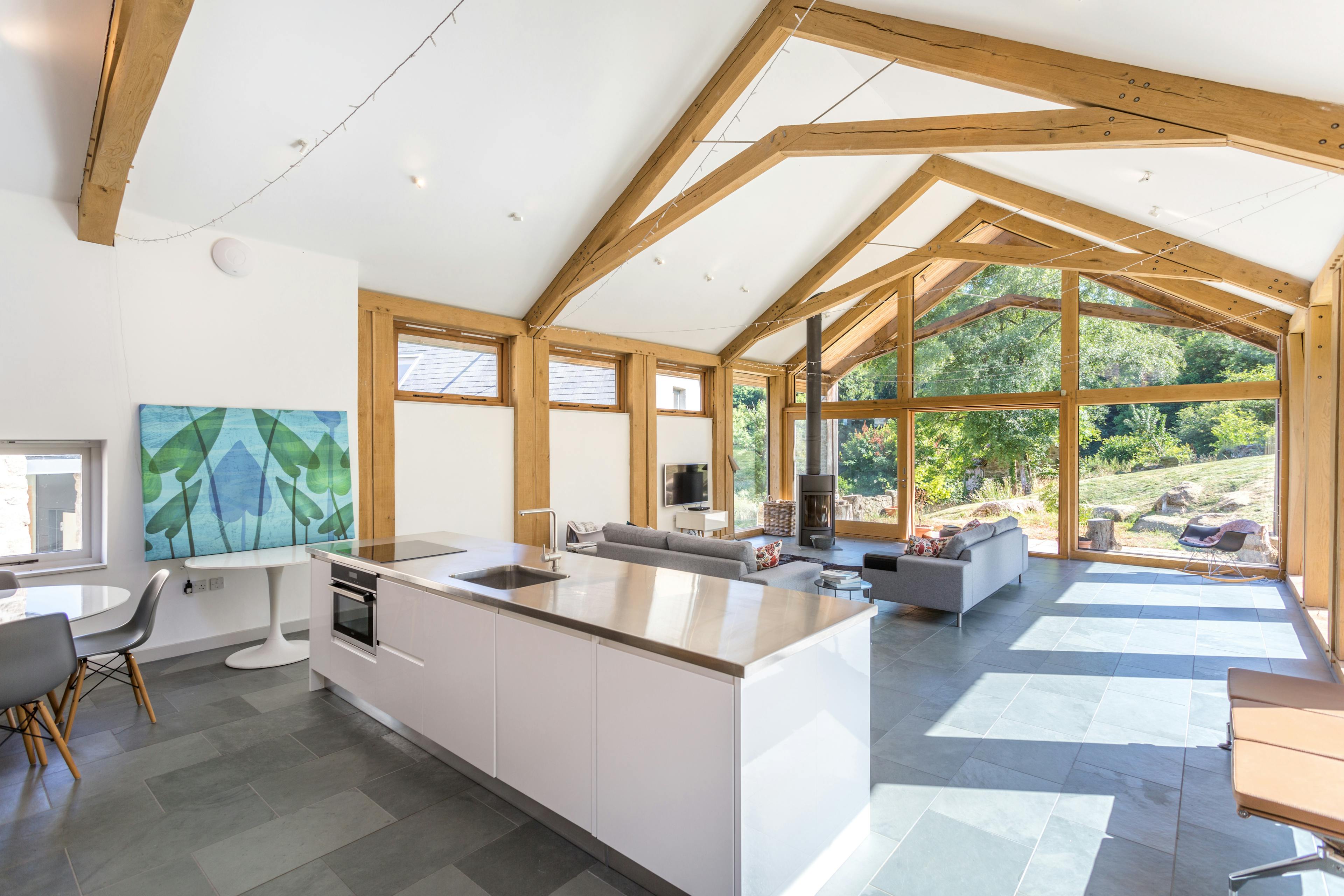 An open-plan annex featuring a contemporary, minimalist kitchen and living area