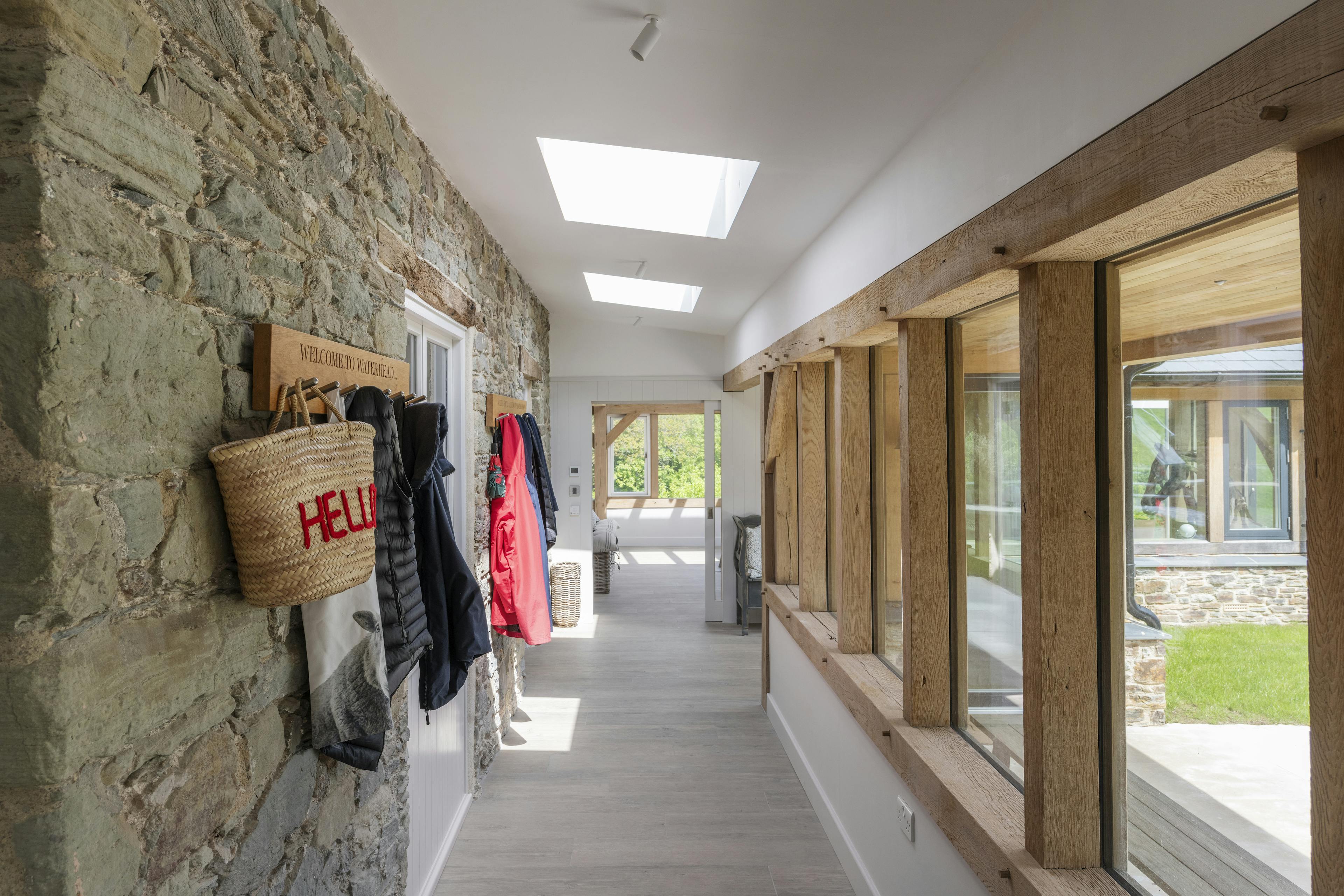 An oak framed corridor with sunshine coming through the rooflights
