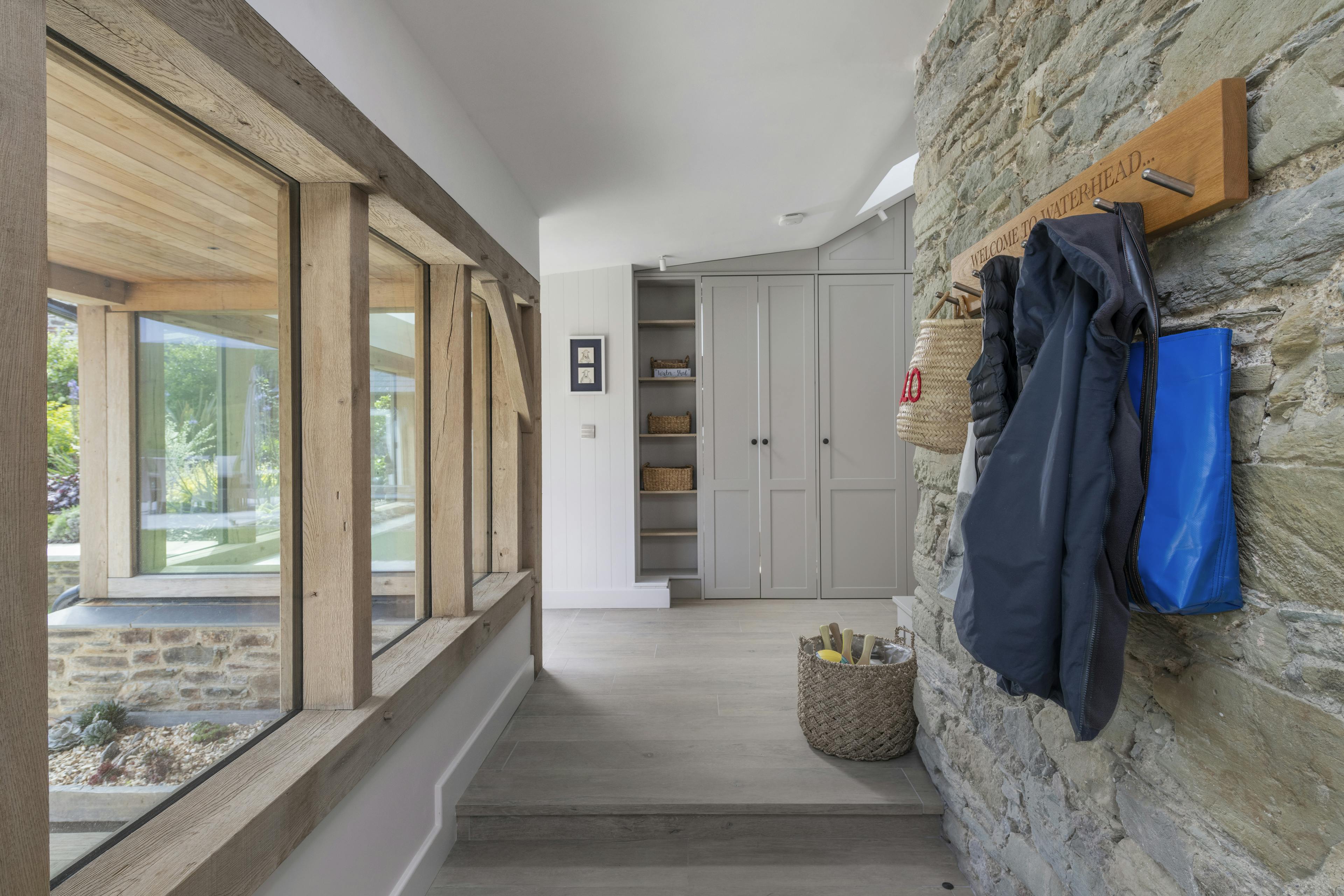An oak framed corridor with bespoke cupboard storage