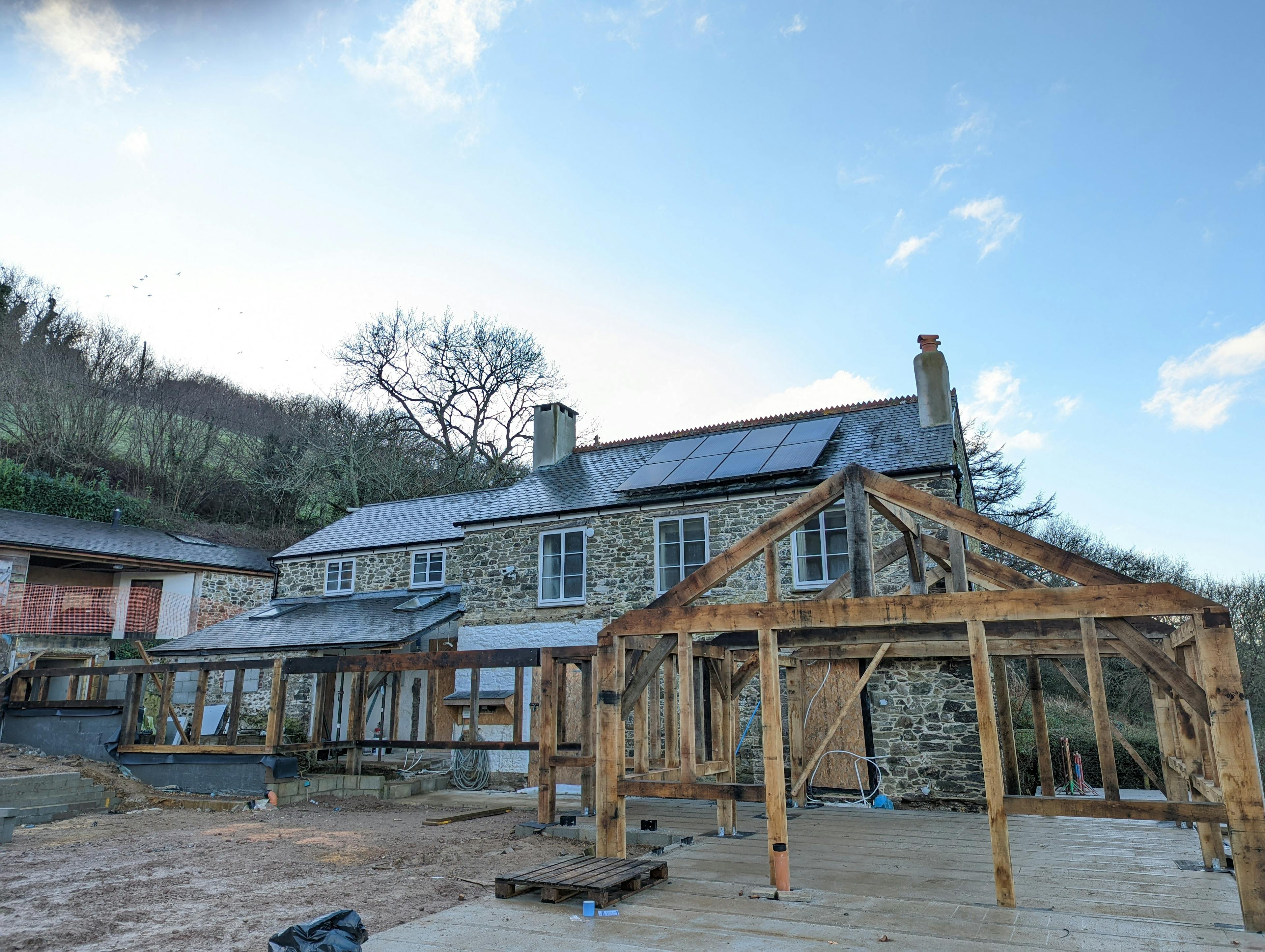 The frame for an oak framed garden room, entrance and corridor extension during installation