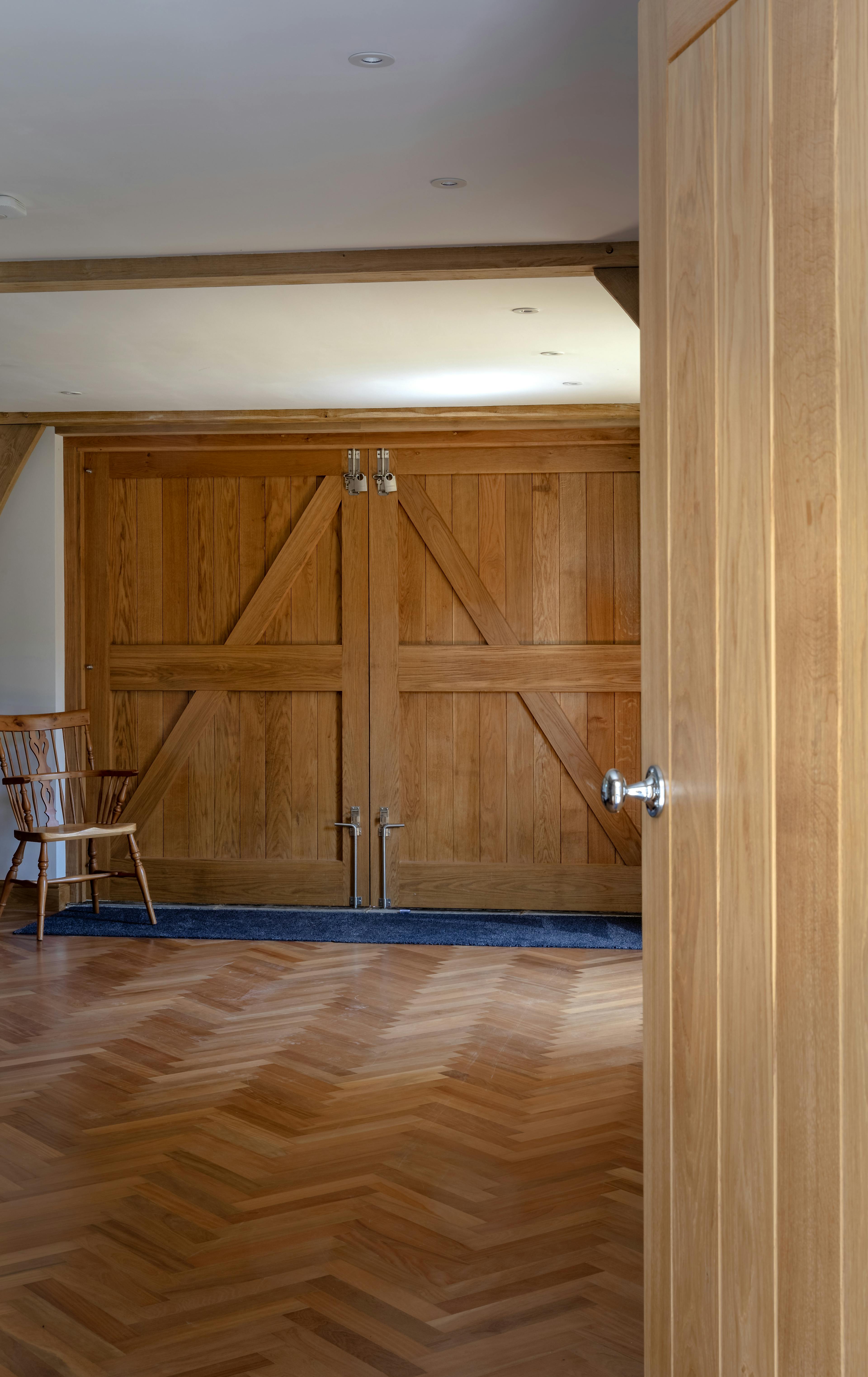 A garage space with parquet flooring inside an oak framed garden annex