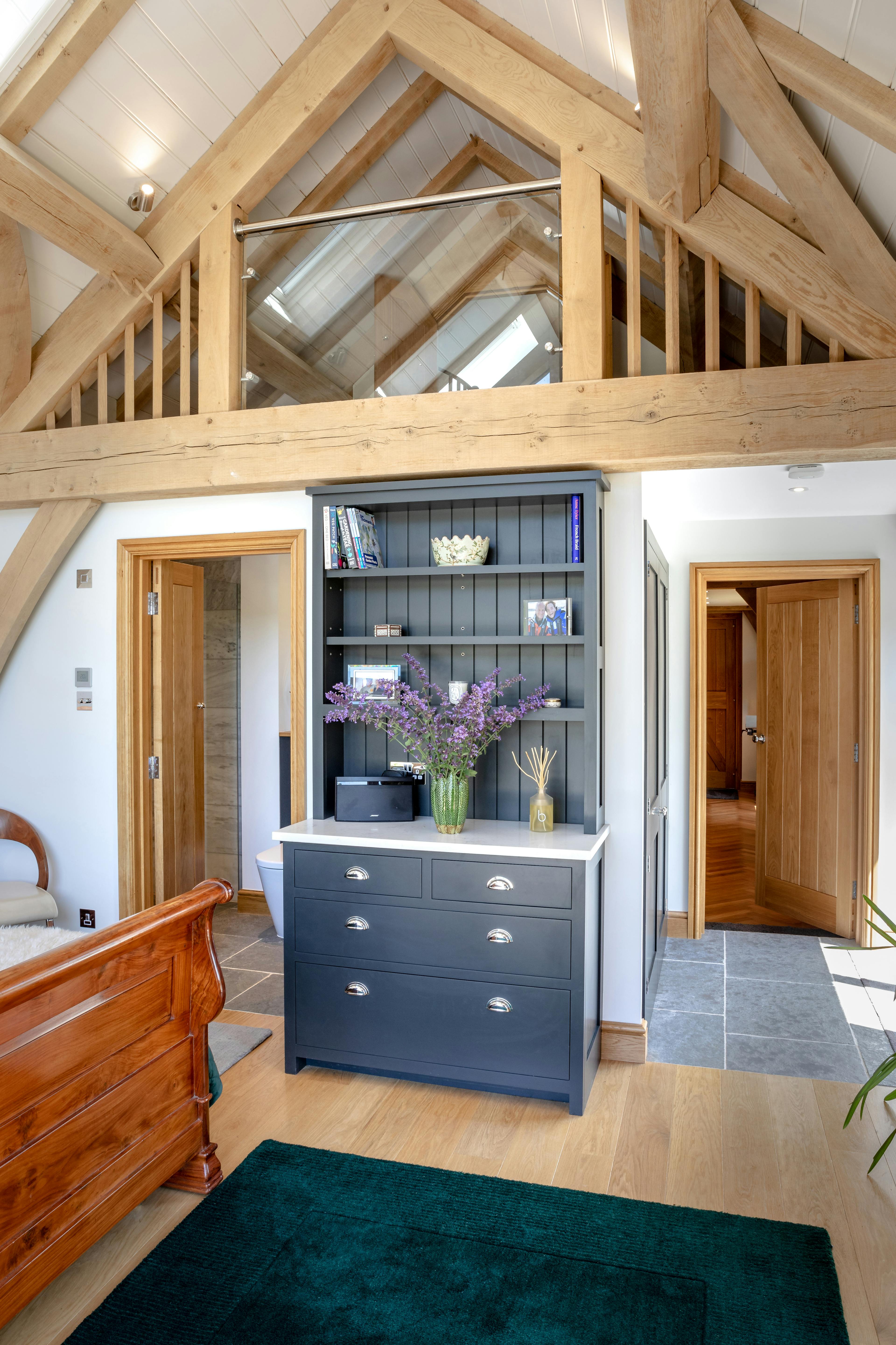 The bedroom area inside an oak framed garden annex with a mezzanine area