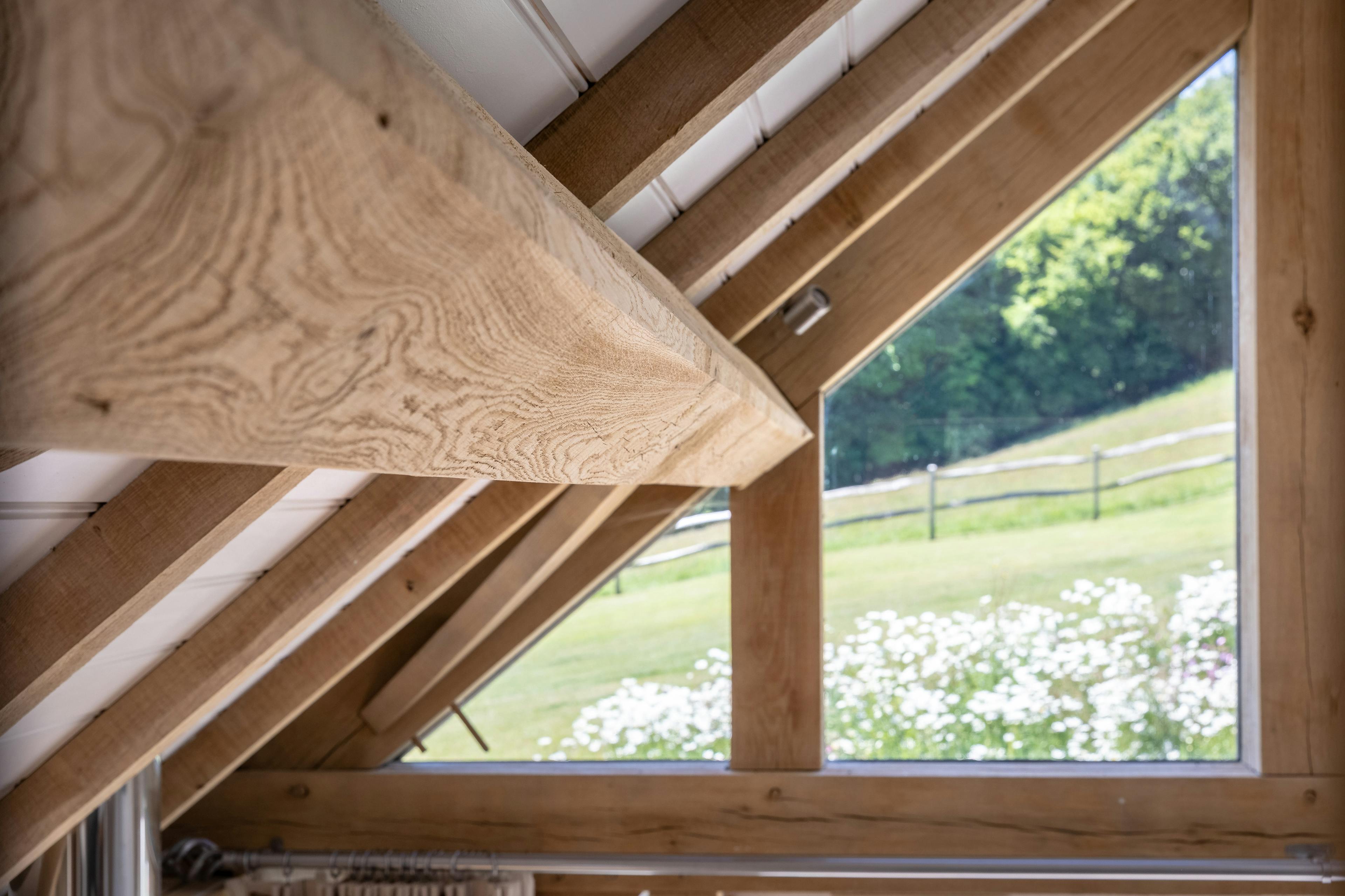 The ceiling inside an oak framed garden annex with white painted roof boarding