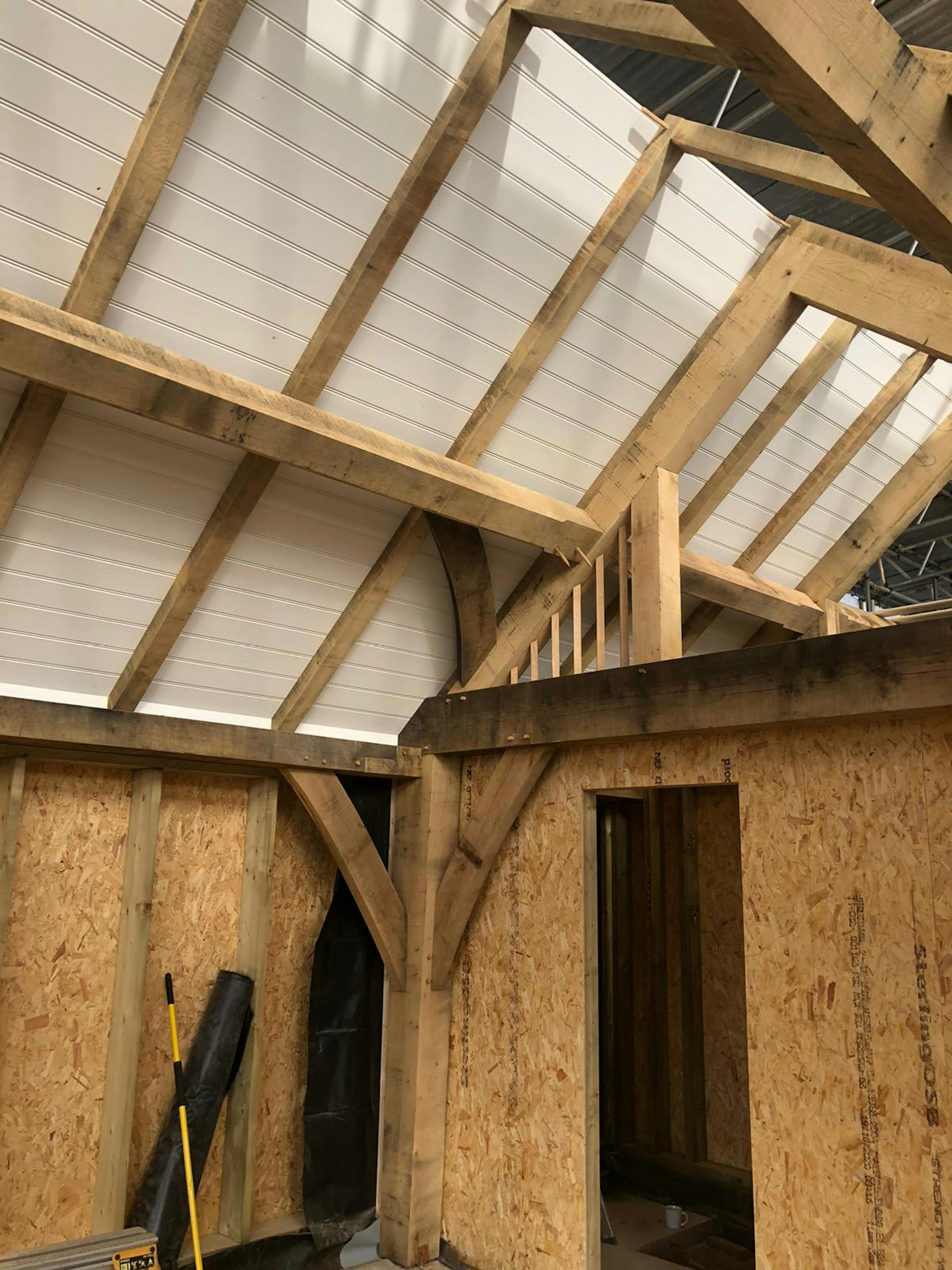 During construction of an oak framed garden annex showing a frame being wrapped