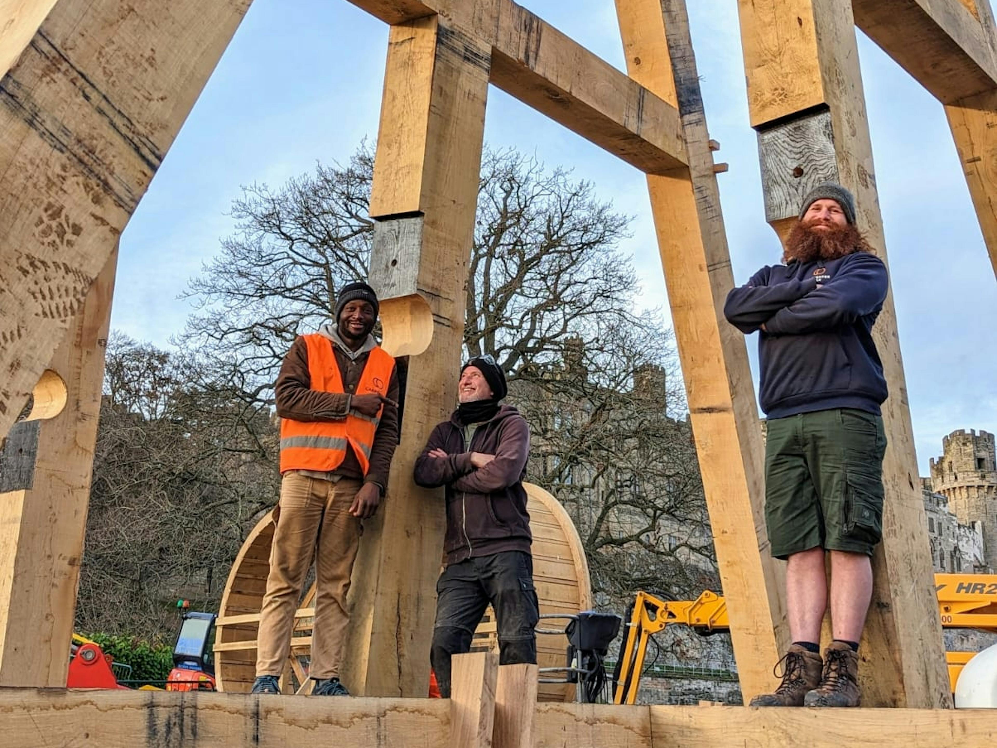 Three carpenters on an timber framed trebuchet