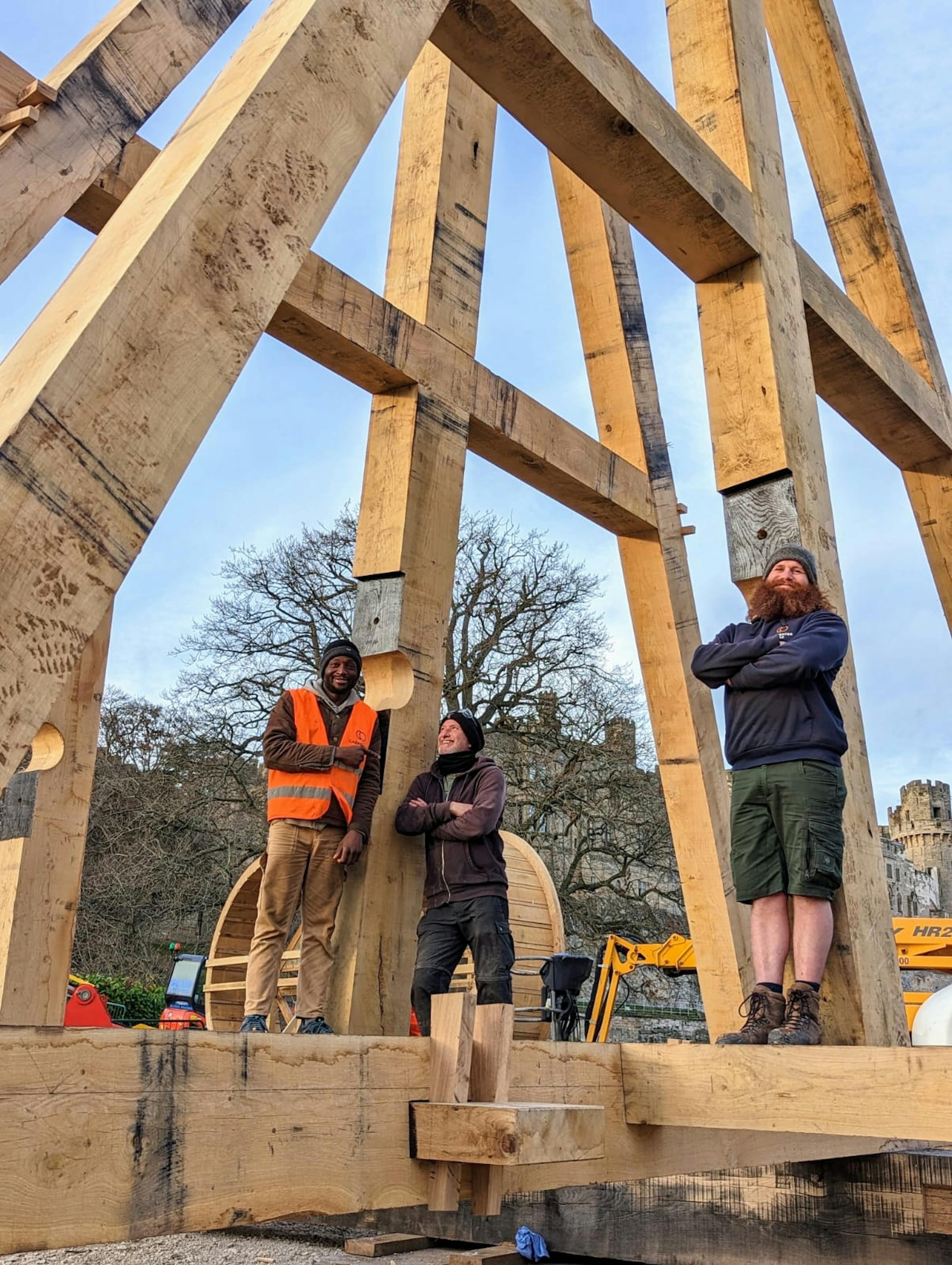 Three carpenters on an timber framed trebuchet