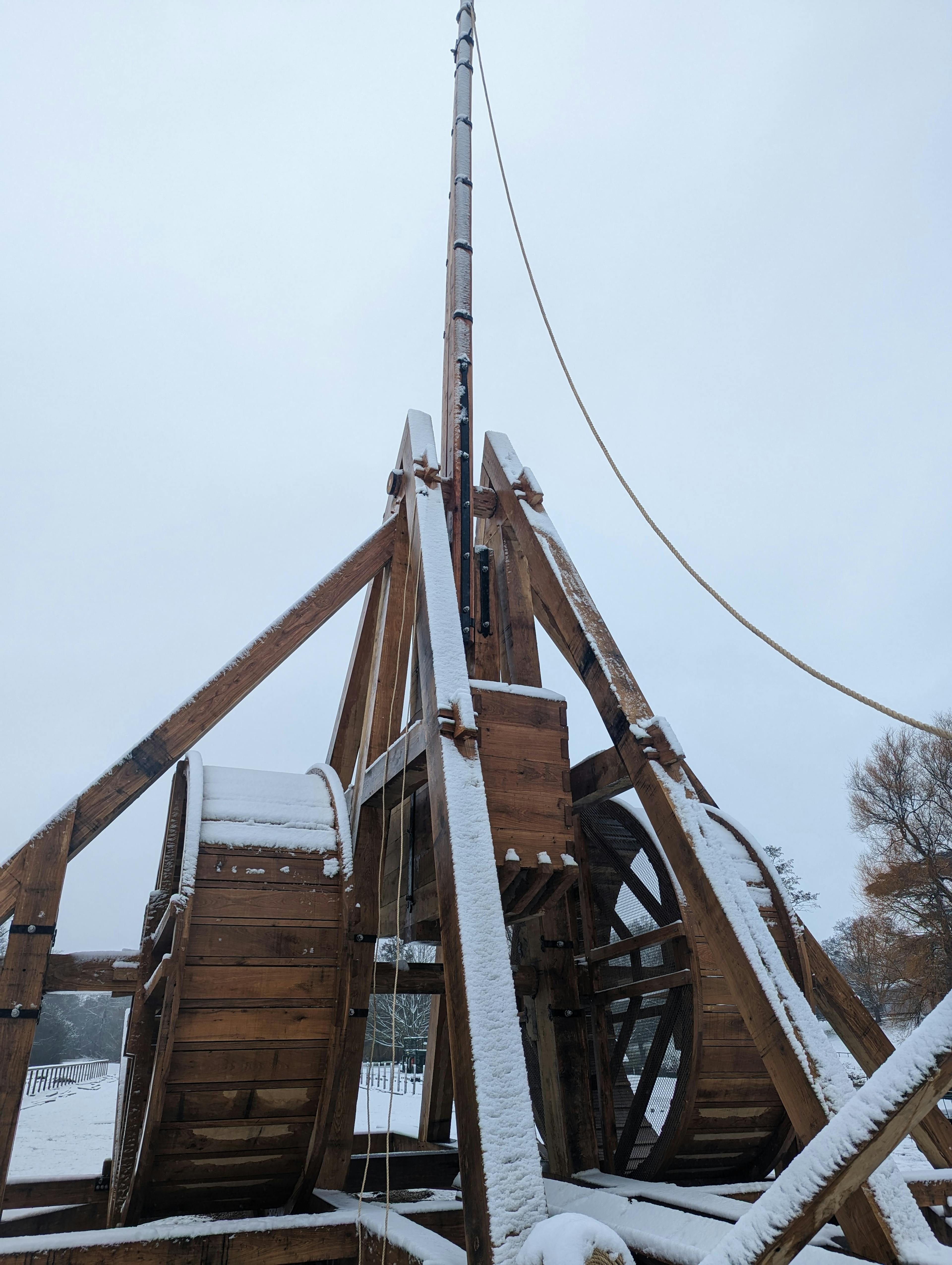 A full scale working oak and ash trebuchet at Warwick Castle with snow on it