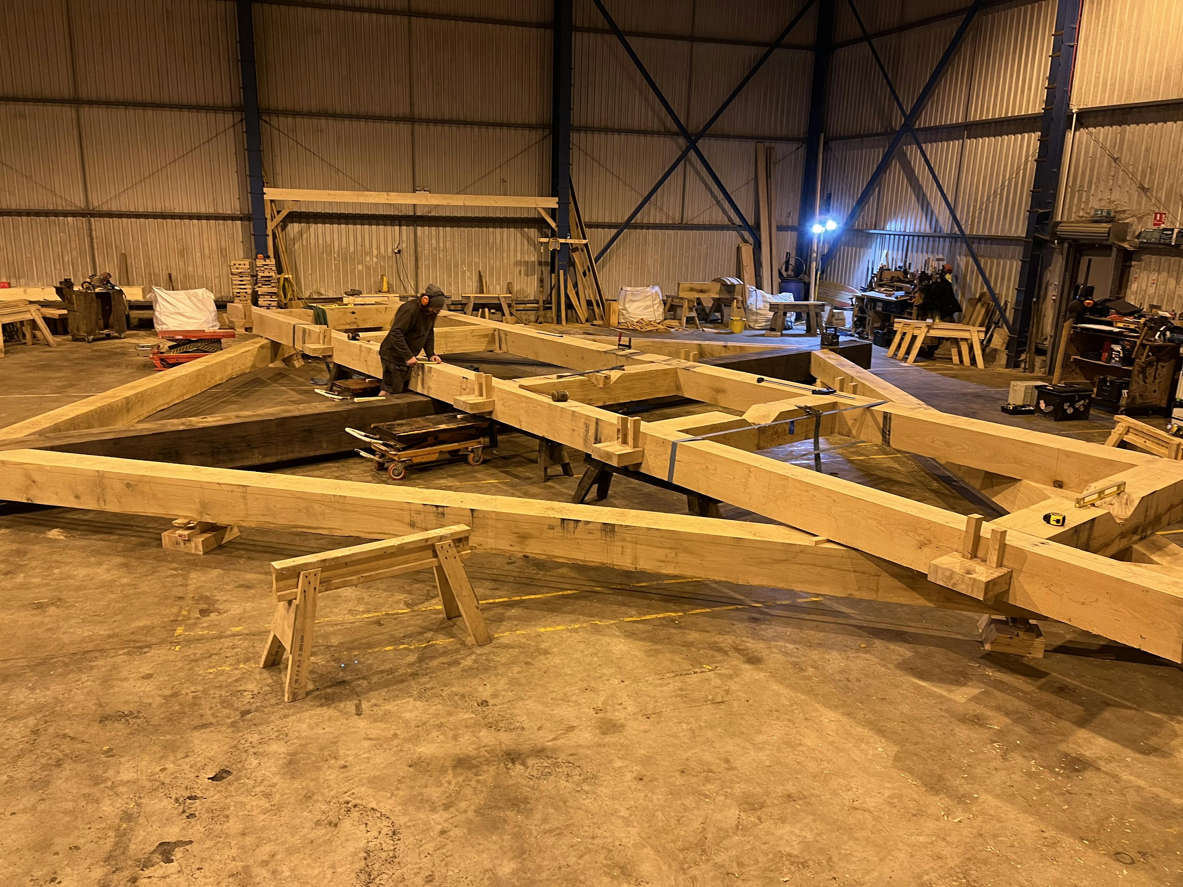 The frame of a full scale working oak and ash trebuchet during manufacturing in a workshop