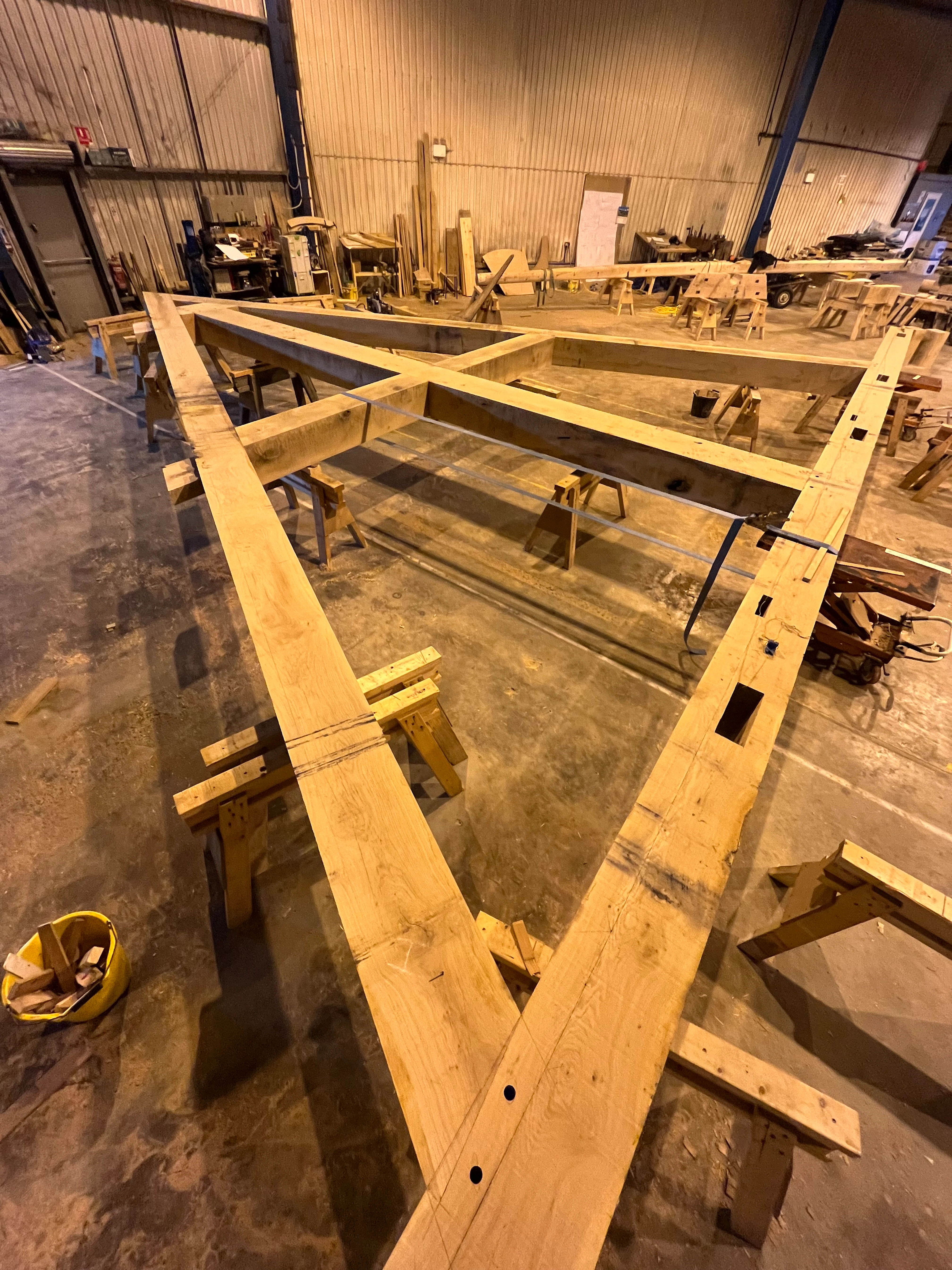 The frame of a full scale working oak and ash trebuchet during manufacturing in a workshop